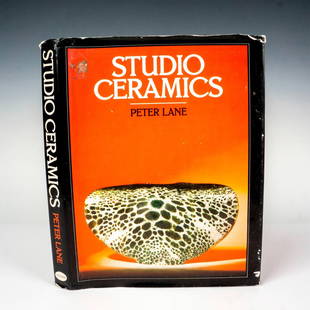 Studio Ceramics, Book by Peter Lane: United Kingdom, William Collins Sons and Co Ltd, 1984. A black hardcover book with the title on the spine in silver lettering along with the original dust jacket. 256-page book about the historical, g