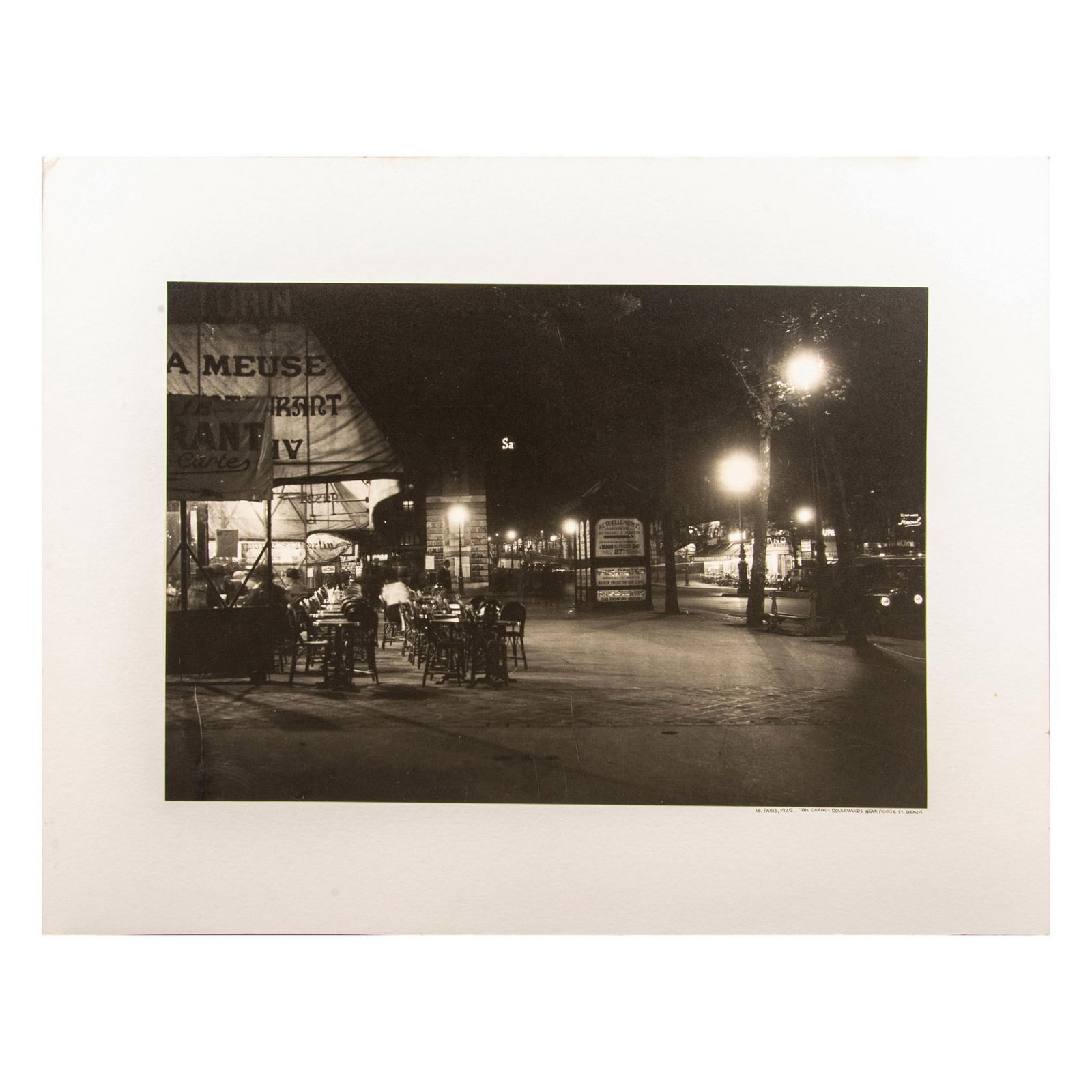 Large Black & White Photogravure, Grands Boulevards by Night: Large black & white photomechanical print on a white board of the Grands Boulevards near Porte St-Denis, Paris by night taken in a Pictorialism style. On lower right: 18. Paris, 1925. The Grands Boule