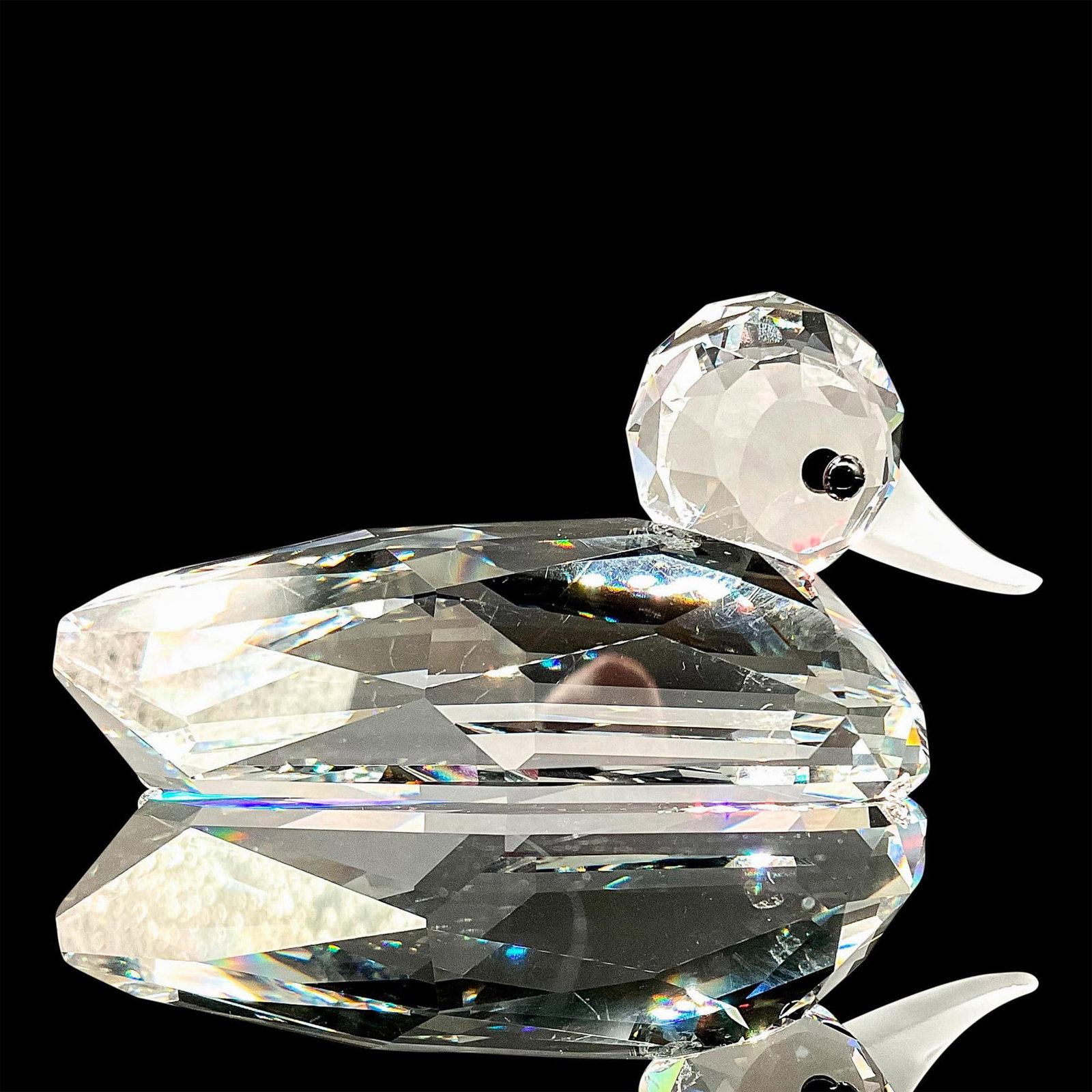 Swarovski Silver Crystal Figurine, Mallard: A sparkling faceted crystal figurine modeled as a mallard duck with black eyes and frosted bill. Swarovski acid mark to base. Original box included. Box dimensions: 2.25"W x 6.25"H. Dimensions: 3.5"L 