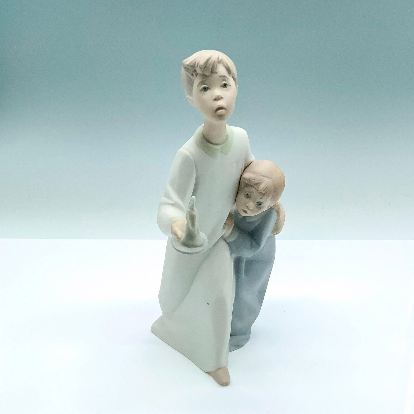Boy And Girl 1014874 - Lladro Porcelain Figurine: Matte finish; Lladro backstamp. Artist: Fulgencio Garcia Issued: 1974 - 1991 Dimensions: 8.25"H x 5"W Manufacturer: Lladro Country of Origin: Spain
