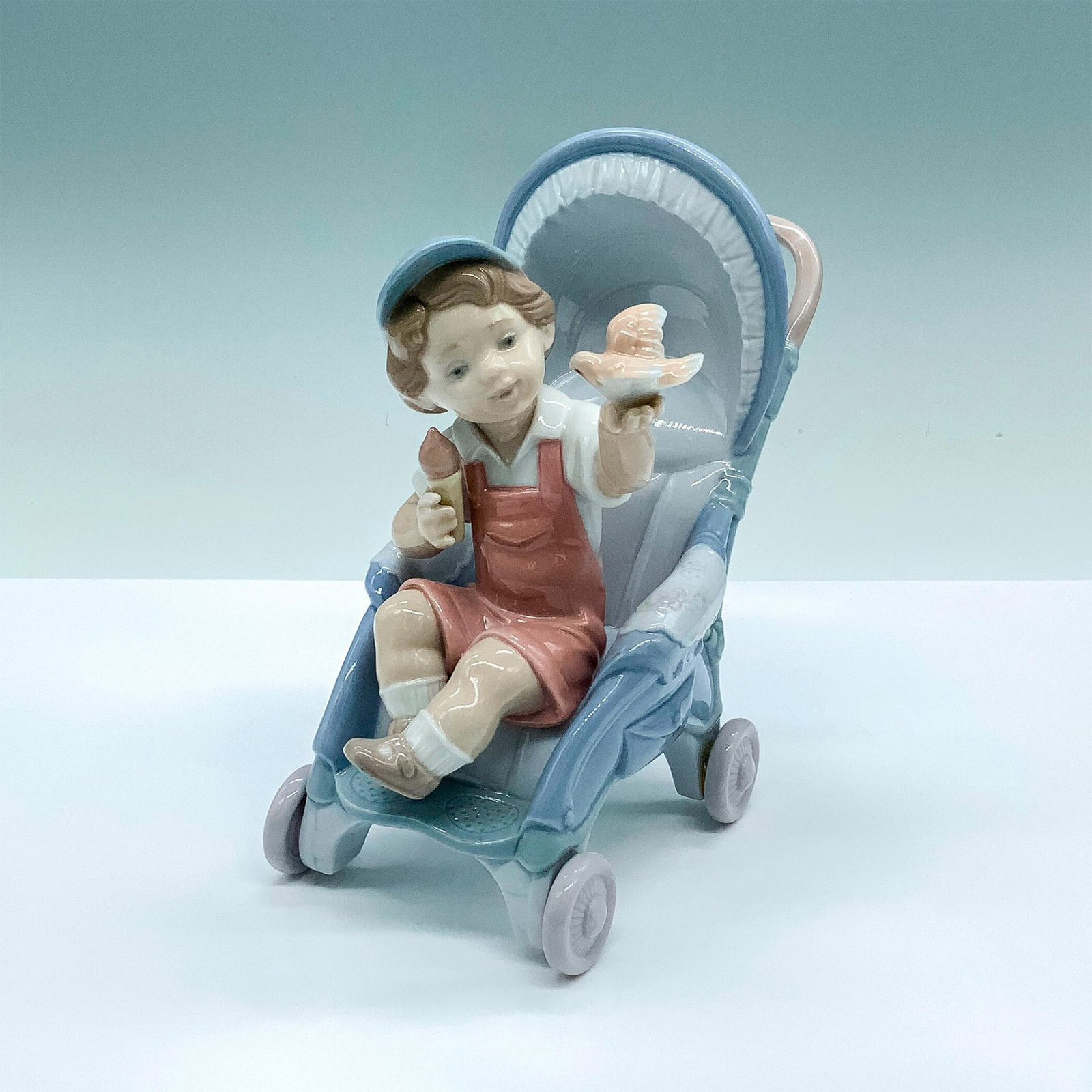 Bundle Of Surprises 1006904 - Lladro Porcelain Figurine: Glossy finish; Lladro backstamp. Artist: Juan Ignacio Aliena Issued: 2002 - 2004 Dimensions: 6.25"H x 4"W Manufacturer: Lladro Country of Origin: Spain