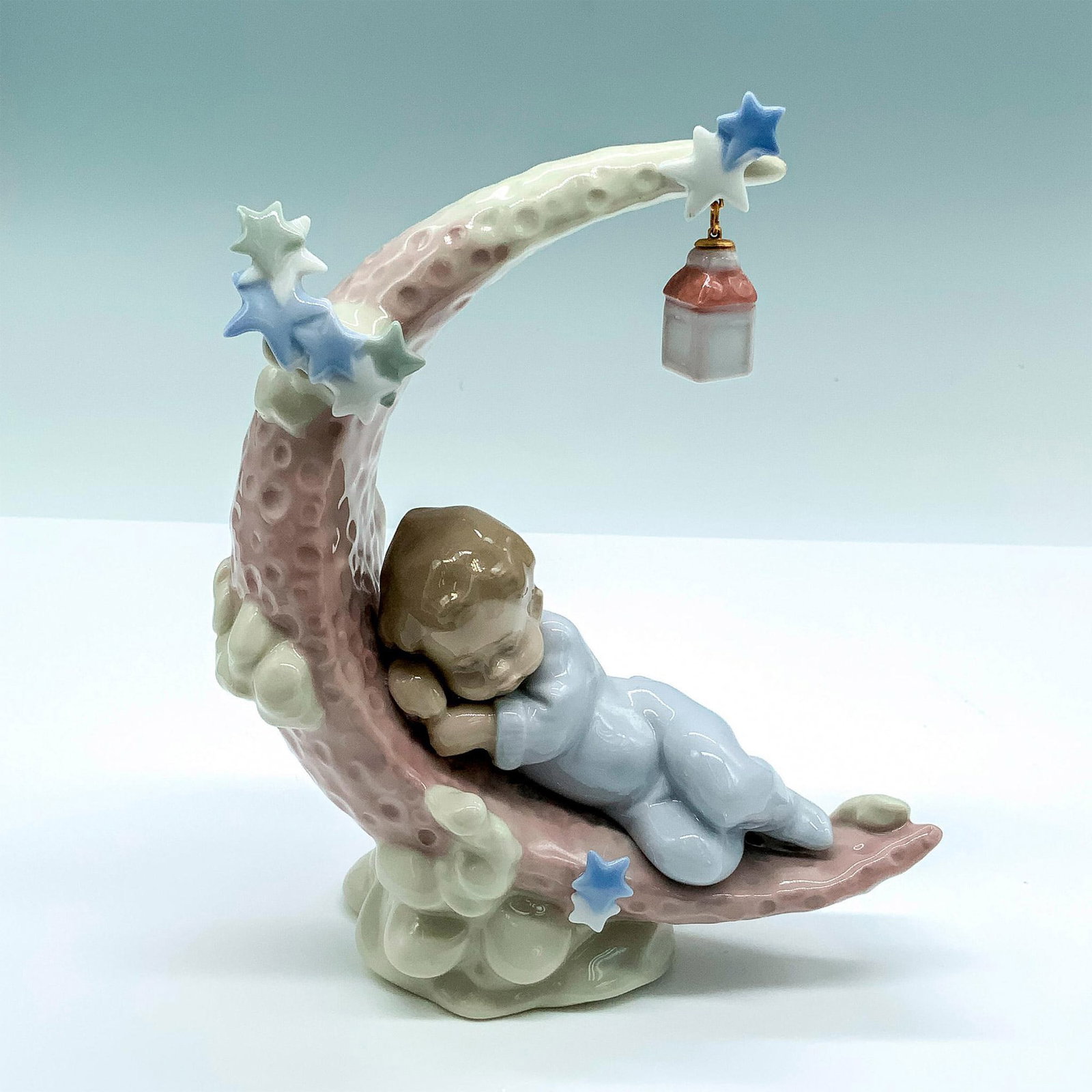 Heavenly Slumber 1006479 - Lladro Porcelain Figurine: Glossy finish; Lladro backstamp. Artist: Antonio Ramos Issued: 1997 Dimensions: 7"H x 6"W Manufacturer: Lladro Country of Origin: Spain