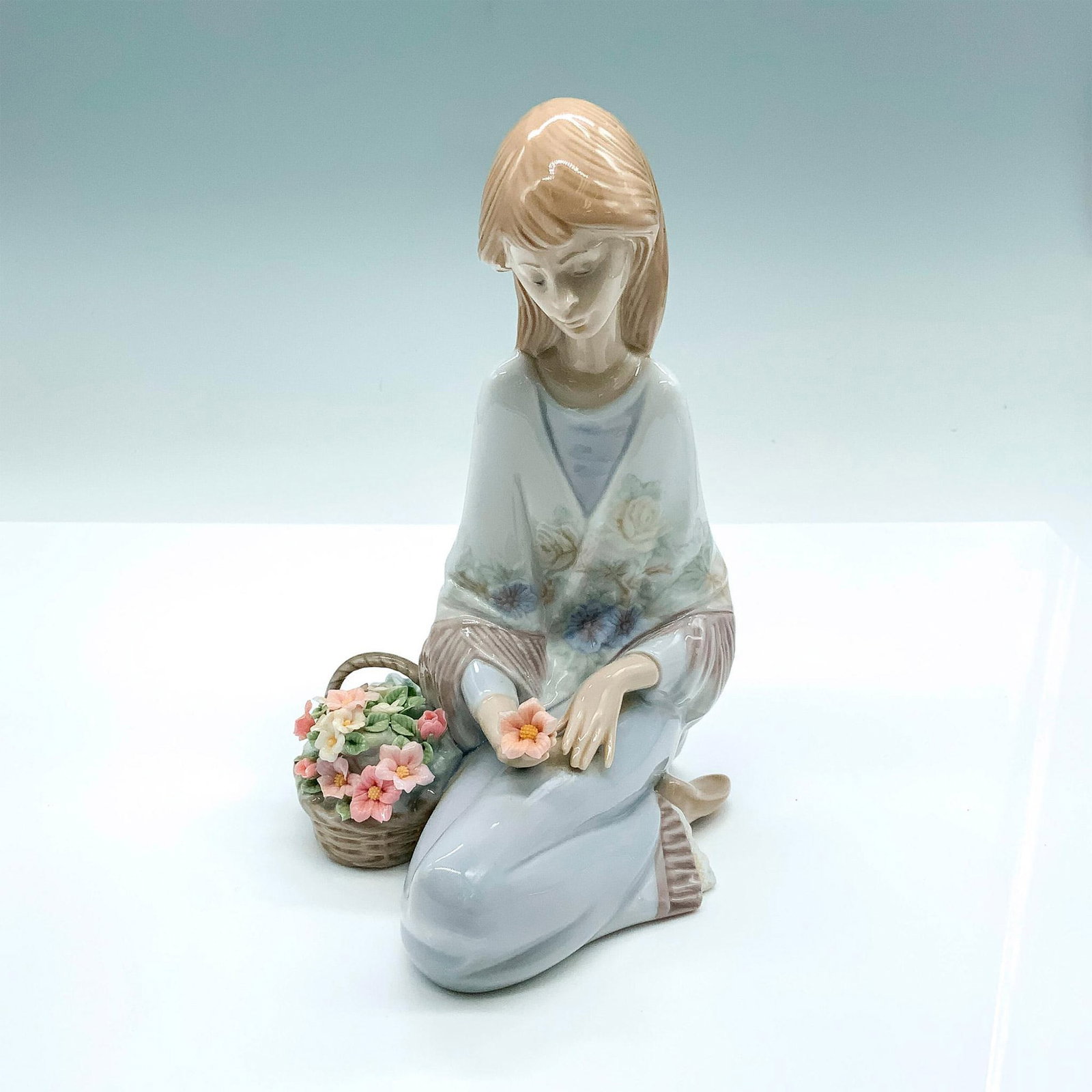 Flower Song 1007607 - Lladro Porcelain Figurine: Glossy finish; Lladro backstamp. Artist: Juan Huerta Issued: 1988 - 1989 Dimensions: 7.5"H x 5.5"W Manufacturer: Lladro Country of Origin: Spain