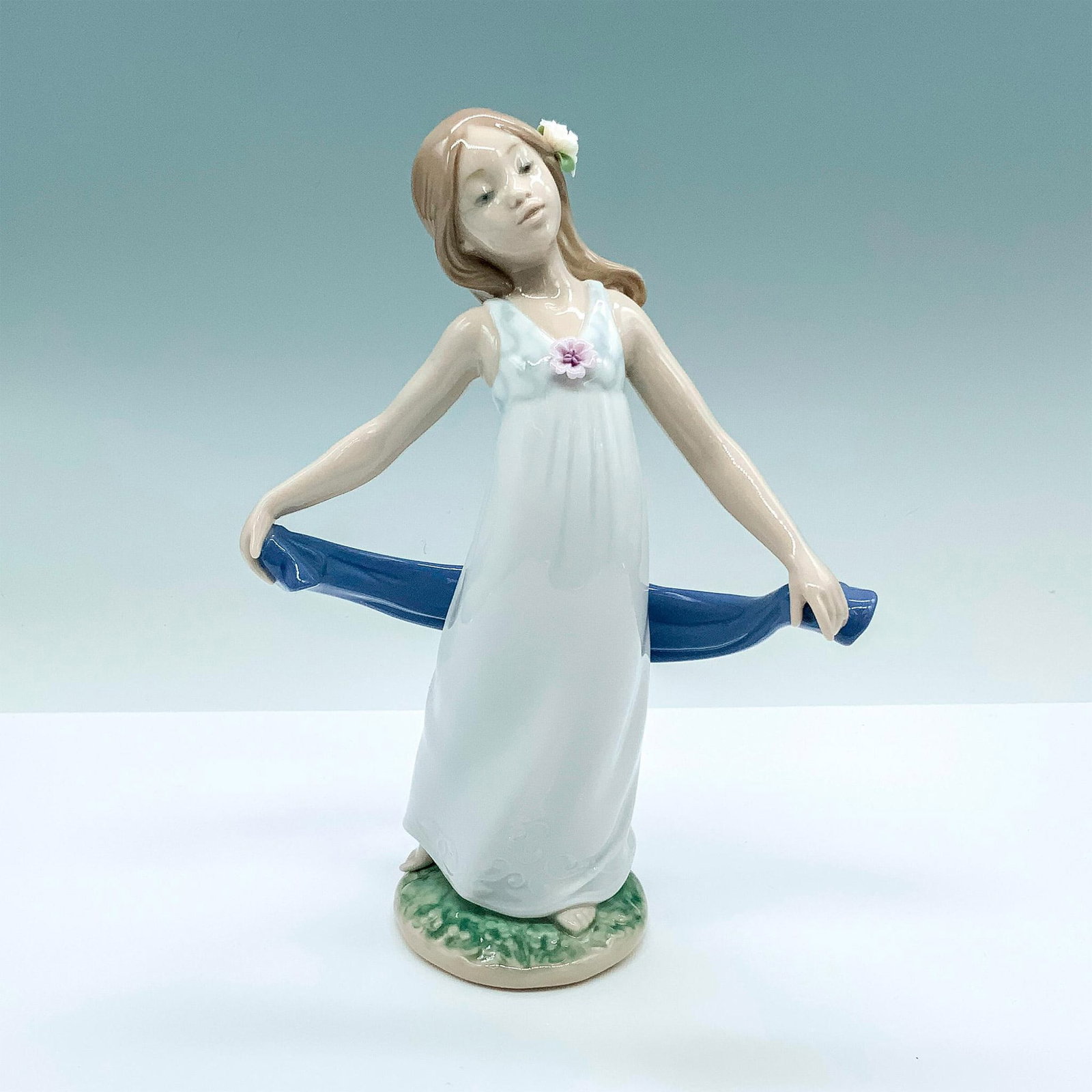 Gentle Breeze 1008363 - Lladro Porcelain Figurine: Glossy finish; Lladro backstamp. Signed by artist on the bottom. Artist: Miguel Angel Santaeulalia Issued: 2008 Dimensions: 8.25"H x 6"W Manufacturer: Lladro Country of Origin: Spain