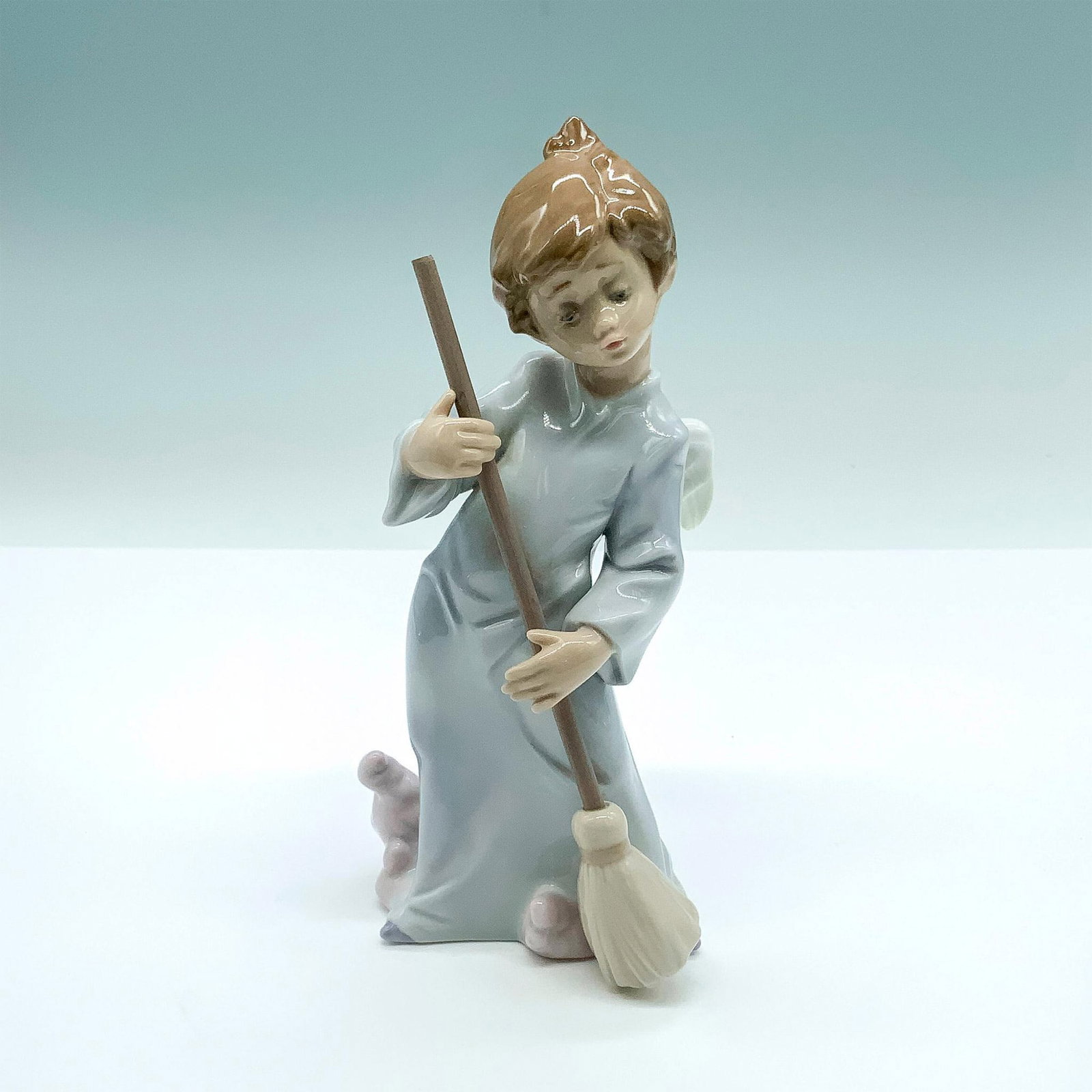 Sweep Away The Clouds 1005726 - Lladro Porcelain Figurine: Glossy finish; Lladro backstamp. Artist: Francisco Polope Issued: 1990 - 2002 Dimensions: 6.5"H Manufacturer: Lladro Country of Origin: Spain