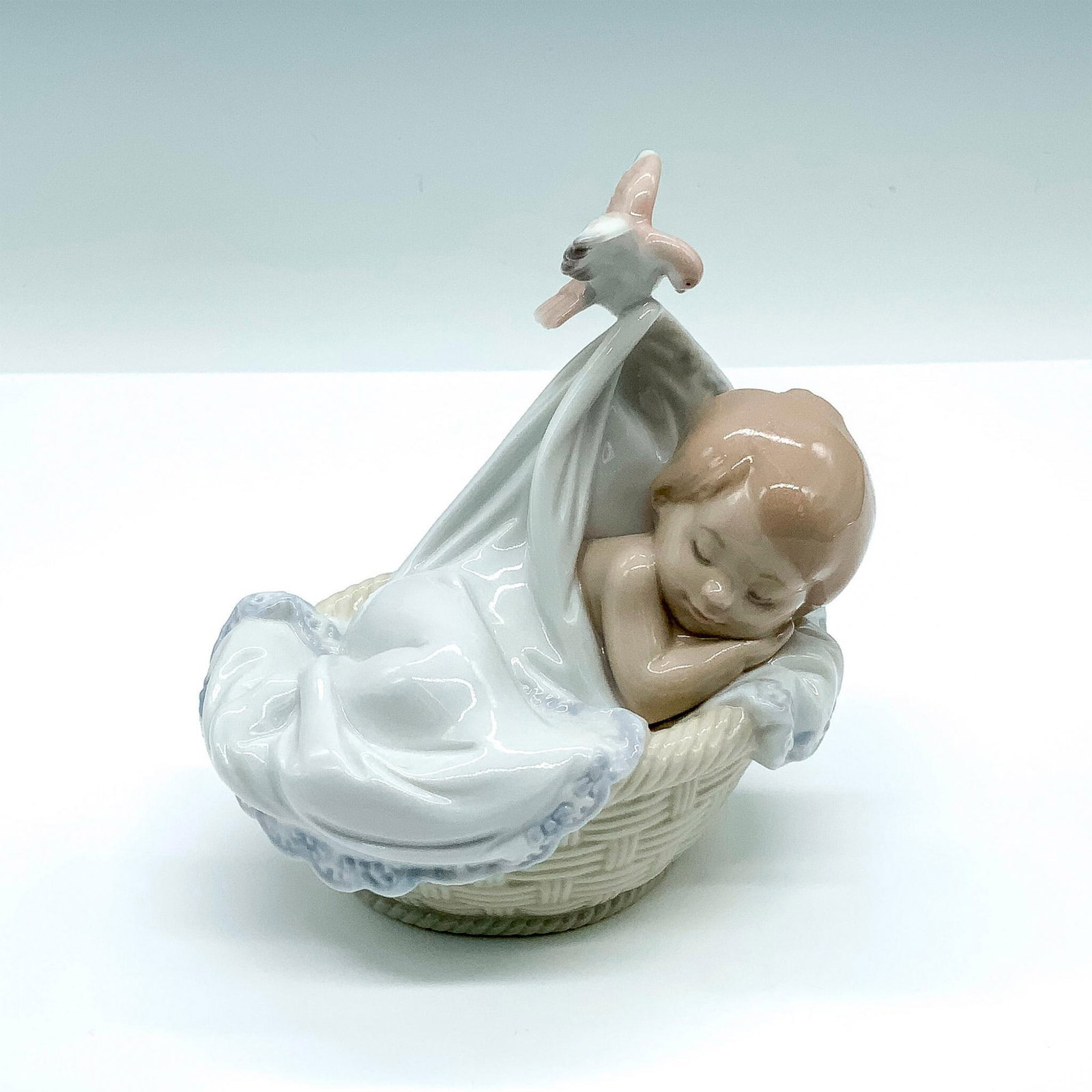 Tender Dreams 1006656 - Lladro Porcelain Figurine: Glossy finish; Lladro backstamp. Artist: Virginia Gonzalez Issued: 2000 Dimensions: 5"H x 5.5"W Manufacturer: Lladro Country of Origin: Spain
