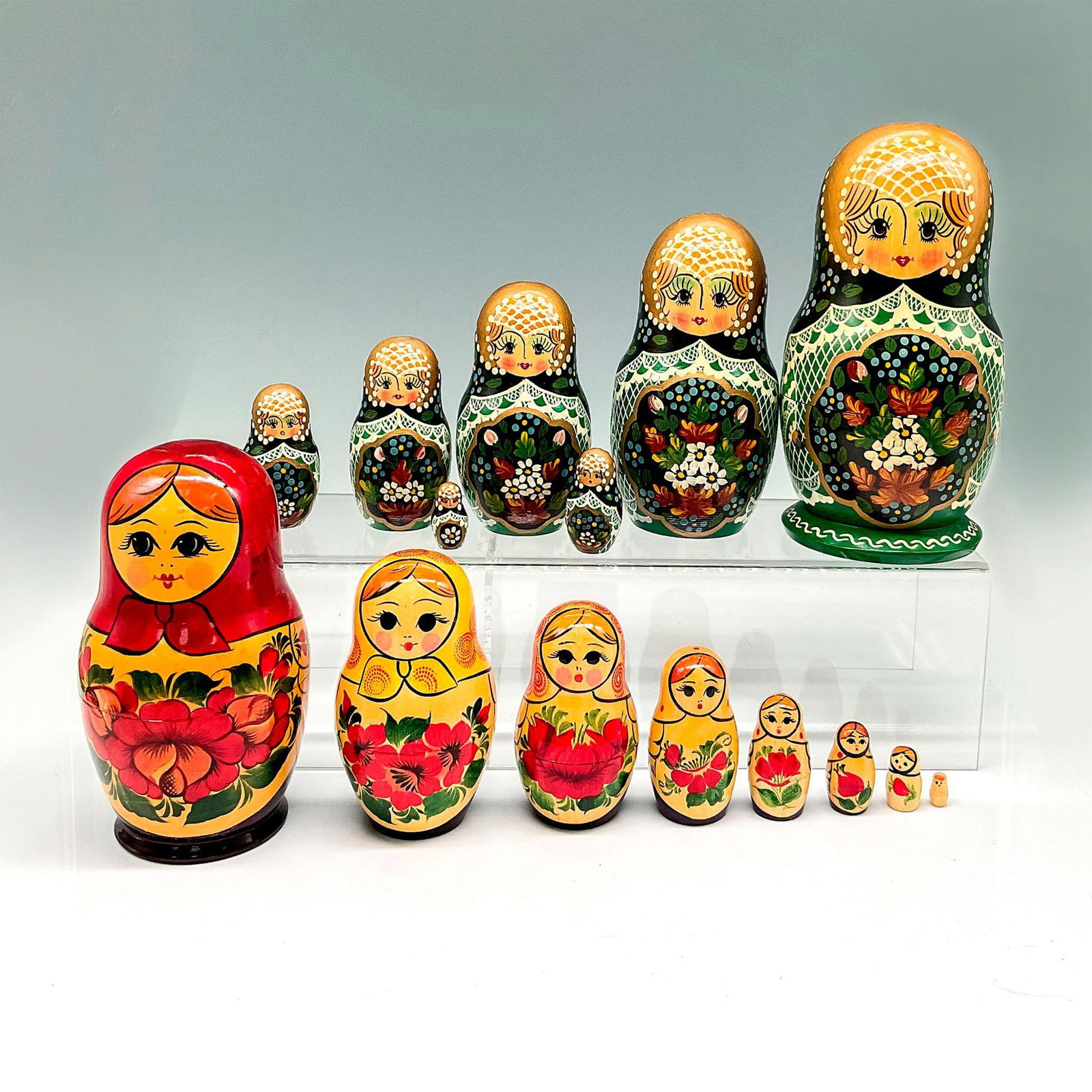2pc Vintage Russian Matryoshka Nesting Doll Figurines: Lacquered wood design over forest green base of raised net on head with florals in center 7.5"H x 4" dia. Doll has 7 tiers. Signed. Handmade in Russia sticker. Second doll 6.25"H x 3.25" dia. is lacqu