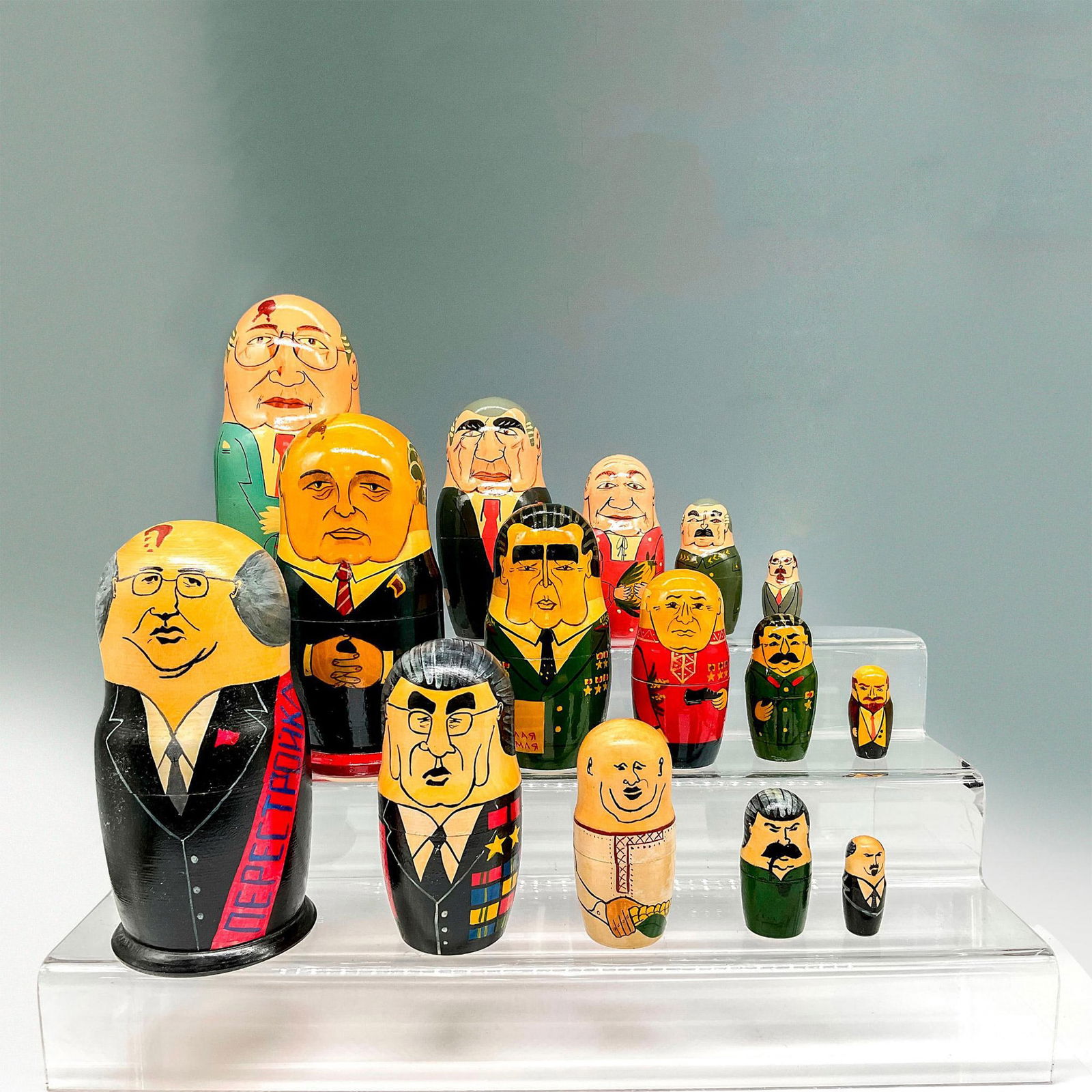 3pc Russian Leaders and Diplomats Nesting Dolls: Lacquered design over wood to create these unique nesting dolls. Each set has 5 dolls. No signature or backstamp. Largest piece: 7.5"H x 3.5" diameter. Issued: 20th century