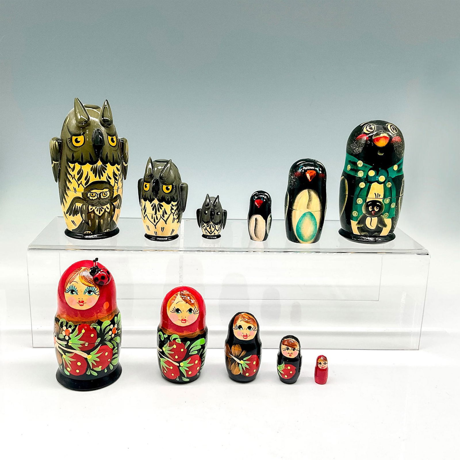 3pc Vintage Hand Painted Russian Nesting Dolls: Mixed lot of lacquered, hand painted dolls including Matryoshka is red lacquer with floral design that has 5 tiers - 4"H x 2" dia., Owl in olive green lacquer, has 3 tiers - 5"H x 2.5" dia. and Pengui