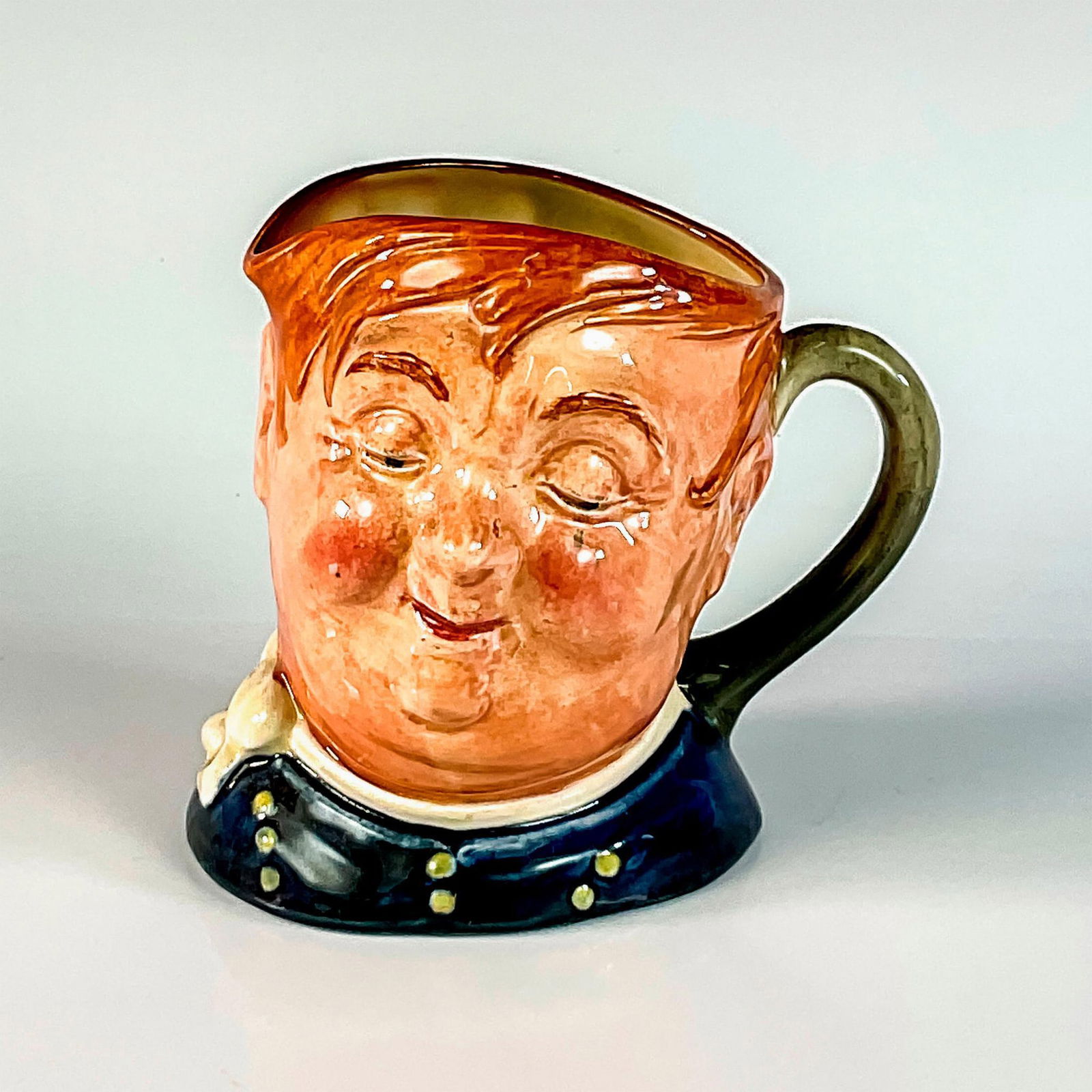 Fat Boy D5840 - Small - Royal Doulton Character Jug: Blue shirt; white scarf. Another wonderful Dickens character Joe, the Fat Boy, was the lazy glutton who worked as servant to Mr. Wardle in " The Pickwick Papers." Royal Doulton backstamp. Artist: Lesl