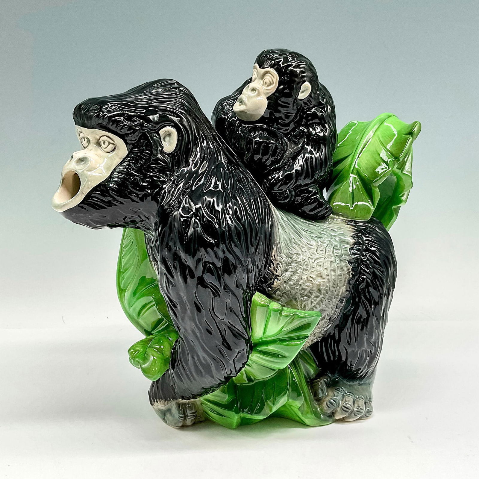 Cardew Design Earthenware Endangered Species Teapot: This magnificent glossy Gorilla and child are colored in black and grey with green leaves around them. Cardew Design backstamp. Issued: 2005 Dimensions: 9.25"L x 5.25"W x 9"H Manufacturer: Cardew Desi