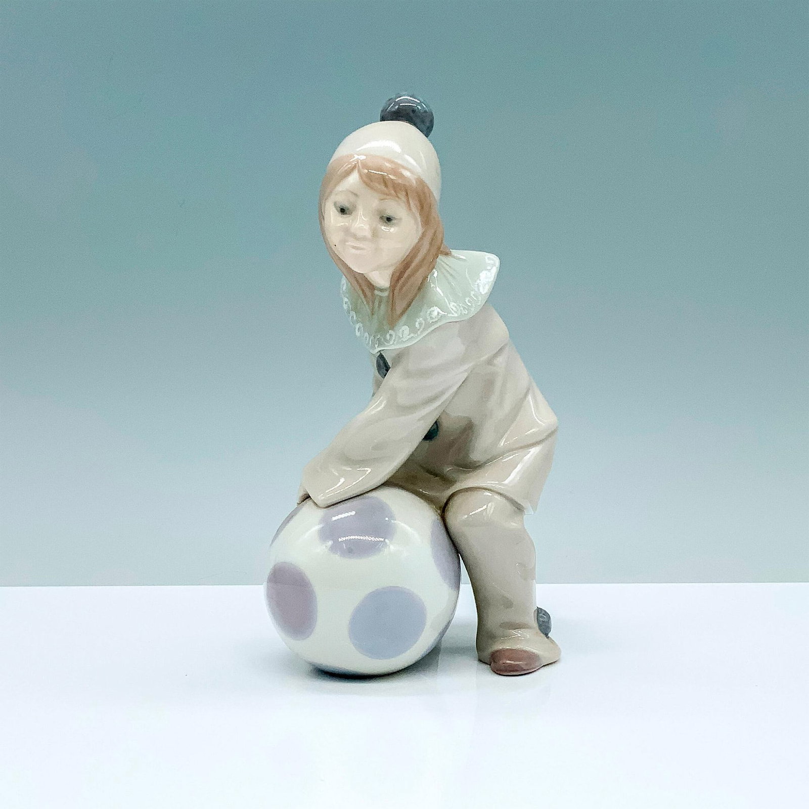 Girl With Ball 1001177 - Lladro Porcelain Figurine: Glossy finish; Lladro backstamp. Artist: Juan Huerta Issued: 1971 - 1981 Dimensions: 6.5"H Manufacturer: Lladro Country of Origin: Spain