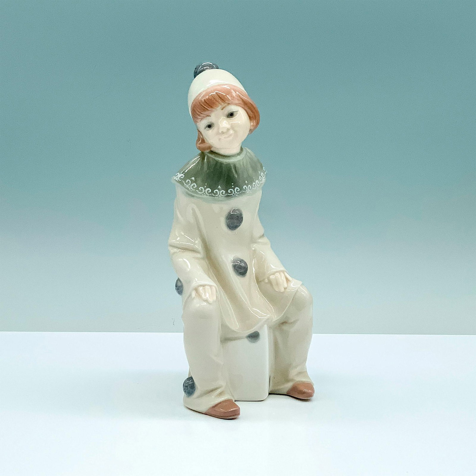 Girl With Dice 1001176 - Lladro Porcelain Figurine: Glossy finish; Lladro backstamp. Artist: Juan Huerta Issued: 1971 - 1981 Dimensions: 7.75"H Manufacturer: Lladro Country of Origin: Spain