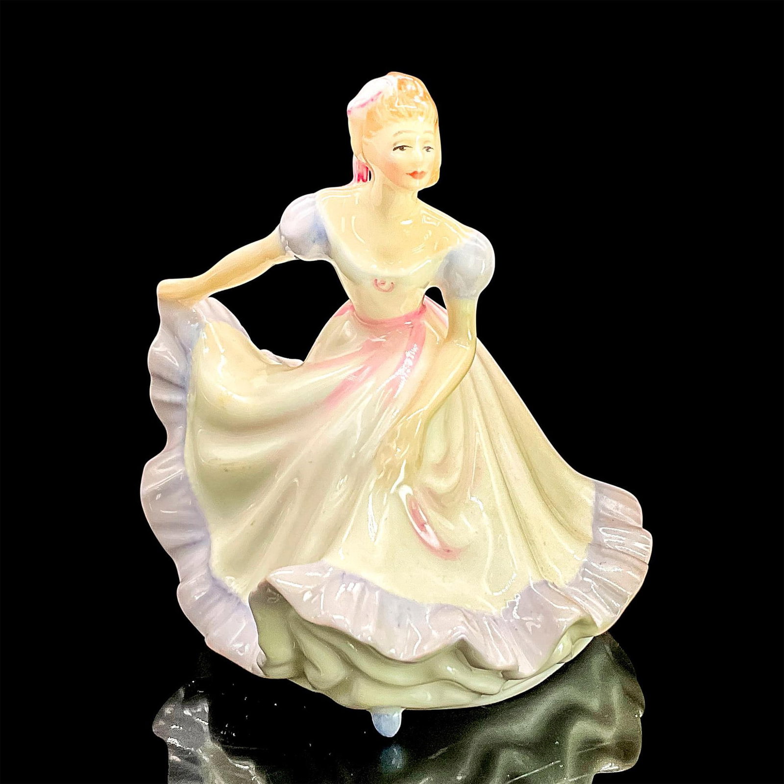 Ninette HN3215 - Royal Doulton Figurine: Glazed bone china figure of lady in a white dress with purple ruffle trim and sleeves, pink accents and hair bow. Part of the Miniatures series. Royal Doulton backstamp. Dimensions: 3.25"L x 3.25"W x 