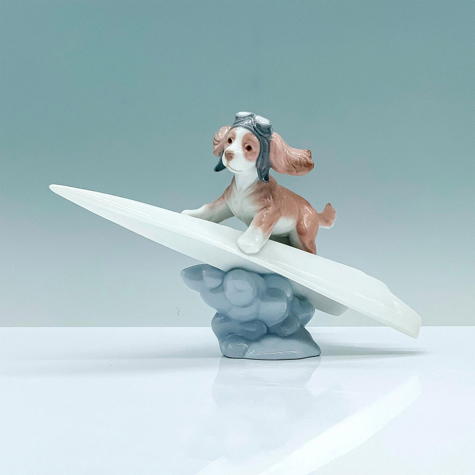 Let's Fly Away 1006665 - Lladro Porcelain Figurine: Glossy finish; Lladro backstamp. Artist: Begonia Jauregui Issued: 2000 Dimensions: 4.75"H x 7.5"W Manufacturer: Lladro Country of Origin: Spain