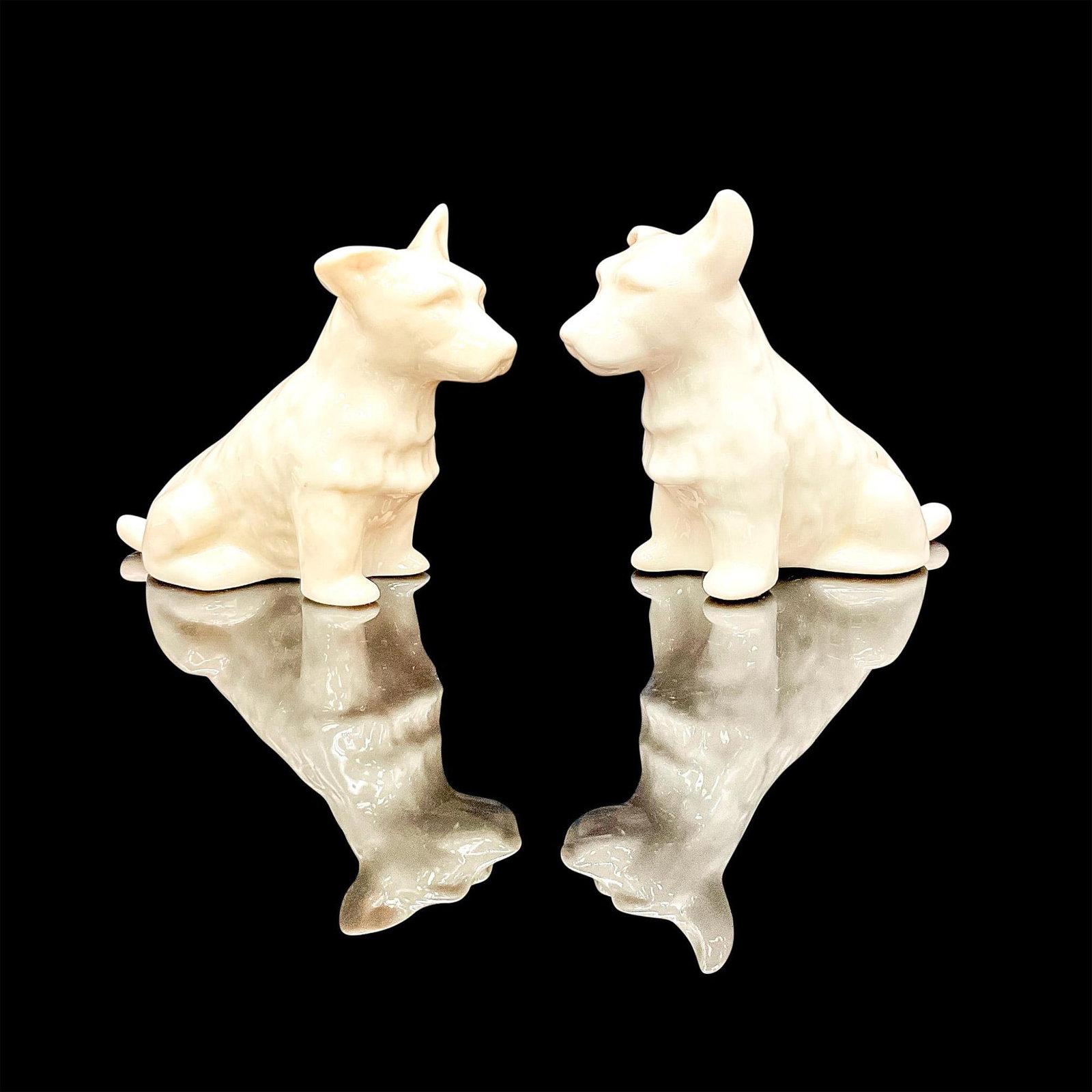 Pair of Belleek Porcelain Scottish Terrier Figurines: Adorable white scotty dogs in a glossy finish. Belleek backstamp in green. Dimensions: 4.5"L x 2"W x 3.5"H Manufacturer: Belleek Country of Origin: Ireland