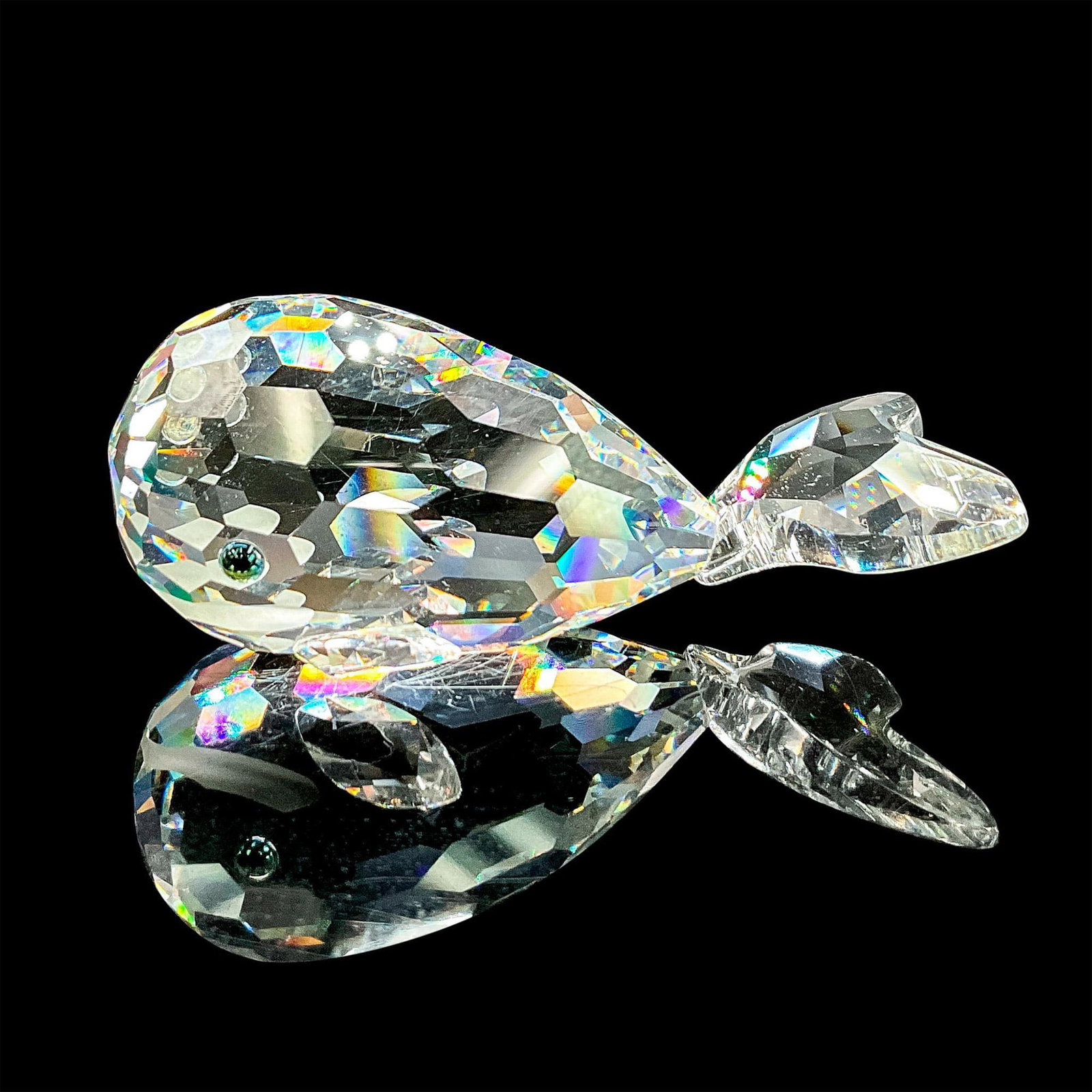 Swarovski Silver Crystal Figurine, Whale: Sparkling clear faceted crystal figure of a smiling whale with blue/green eyes. Swarovski etched mark. Includes original box, 5"H x 3.25"dia. Dimensions: 3"L x 1.5"W x 1.25"H Manufacturer: Swarovski C