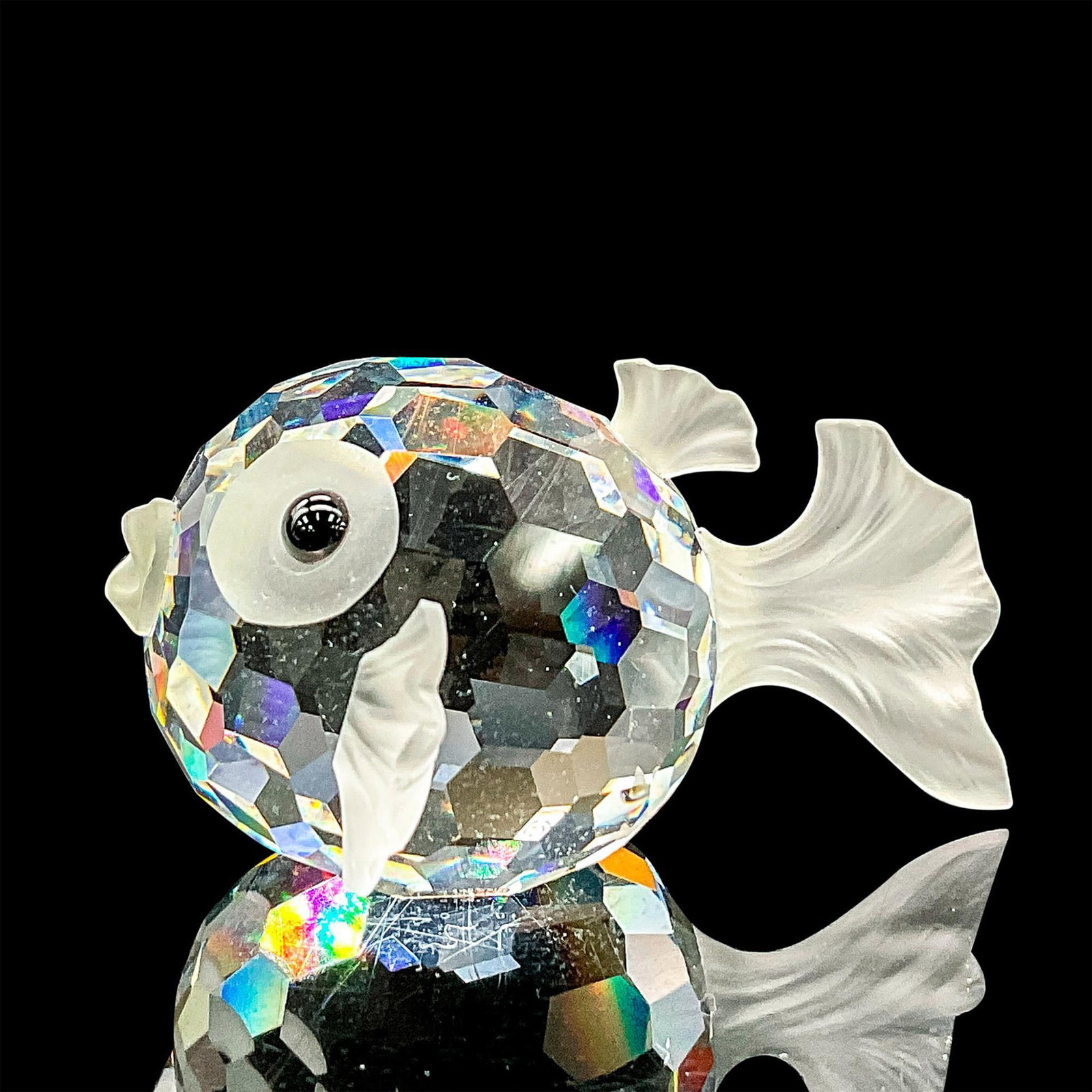 Swarovski Crystal Figurine, Blowfish: Brilliant clear faceted crystal puffer fish with satin tail, fins and mouth. Swarovski etched backstamp. Includes original box, 4"H x 3.25"dia. Dimensions: 2"L x 1.75"W x 1"H Manufacturer: Swarovski C