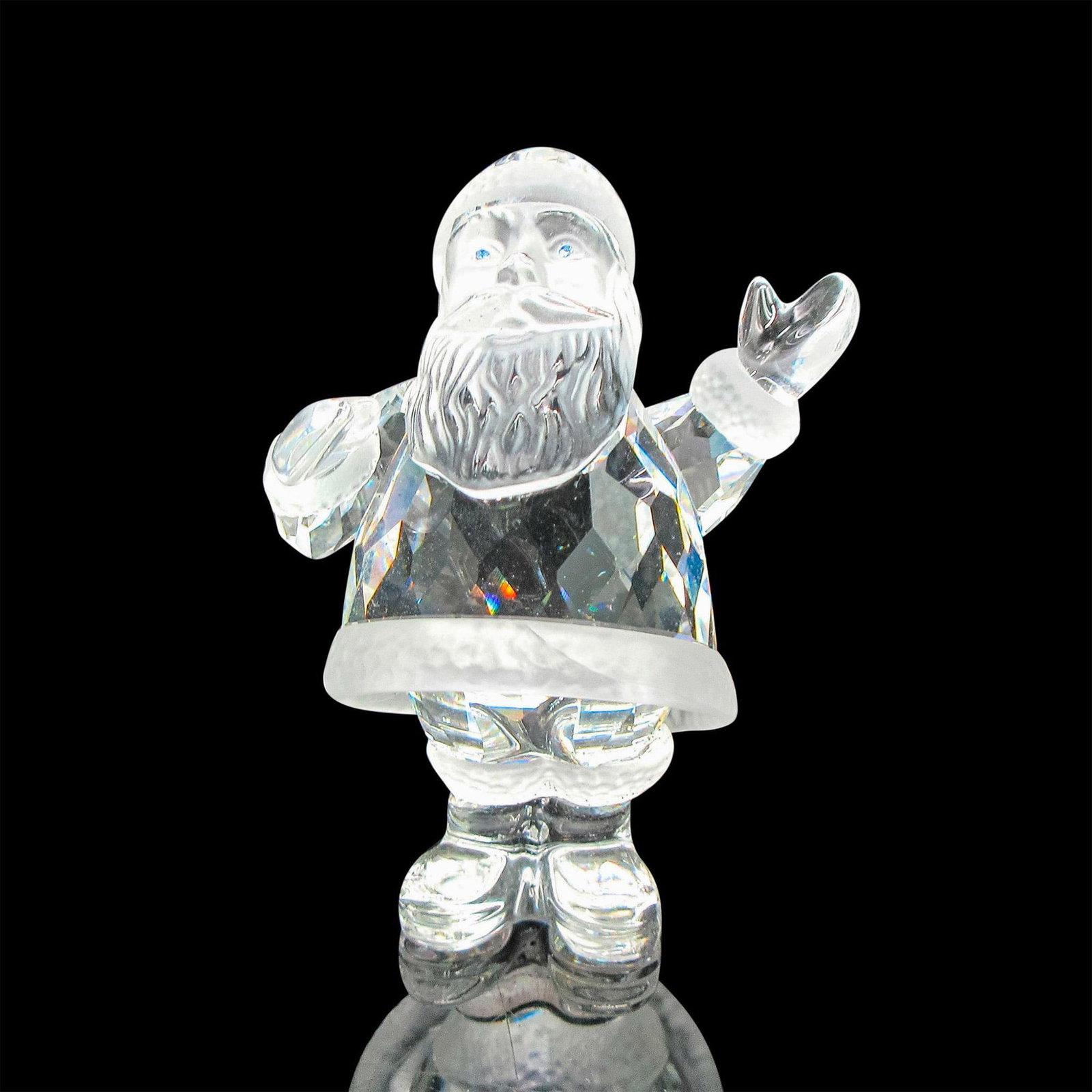 Swarovski Silver Crystal Figurine, Santa Claus: Part of the Exquisite Accents group. Clear crystal body with satin crystal accents on hat, coat and boots. Blue crystal eyes set off his face. Swarovski backstamp. This item has its original box: 4"L 