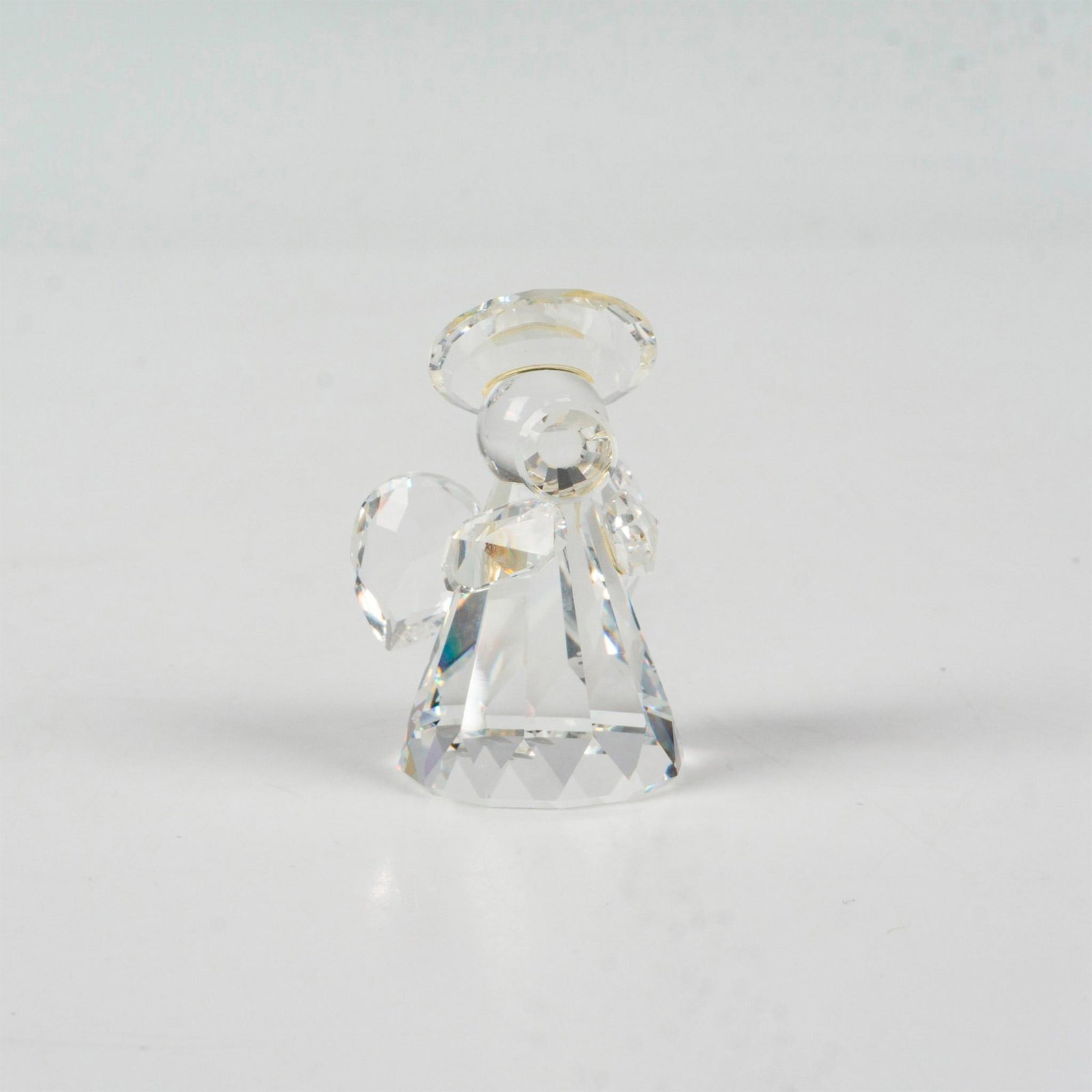 Swarovski Silver Crystal Figurine, Angel Playing Trumpet: Part of the Silver Crystal and Nativity Collections. Clear faceted crystal design with detailed wings, halo and trumpet. Swarovski backstamp. 7475000009. This item has its original box: 2.5"H x 3.25"d