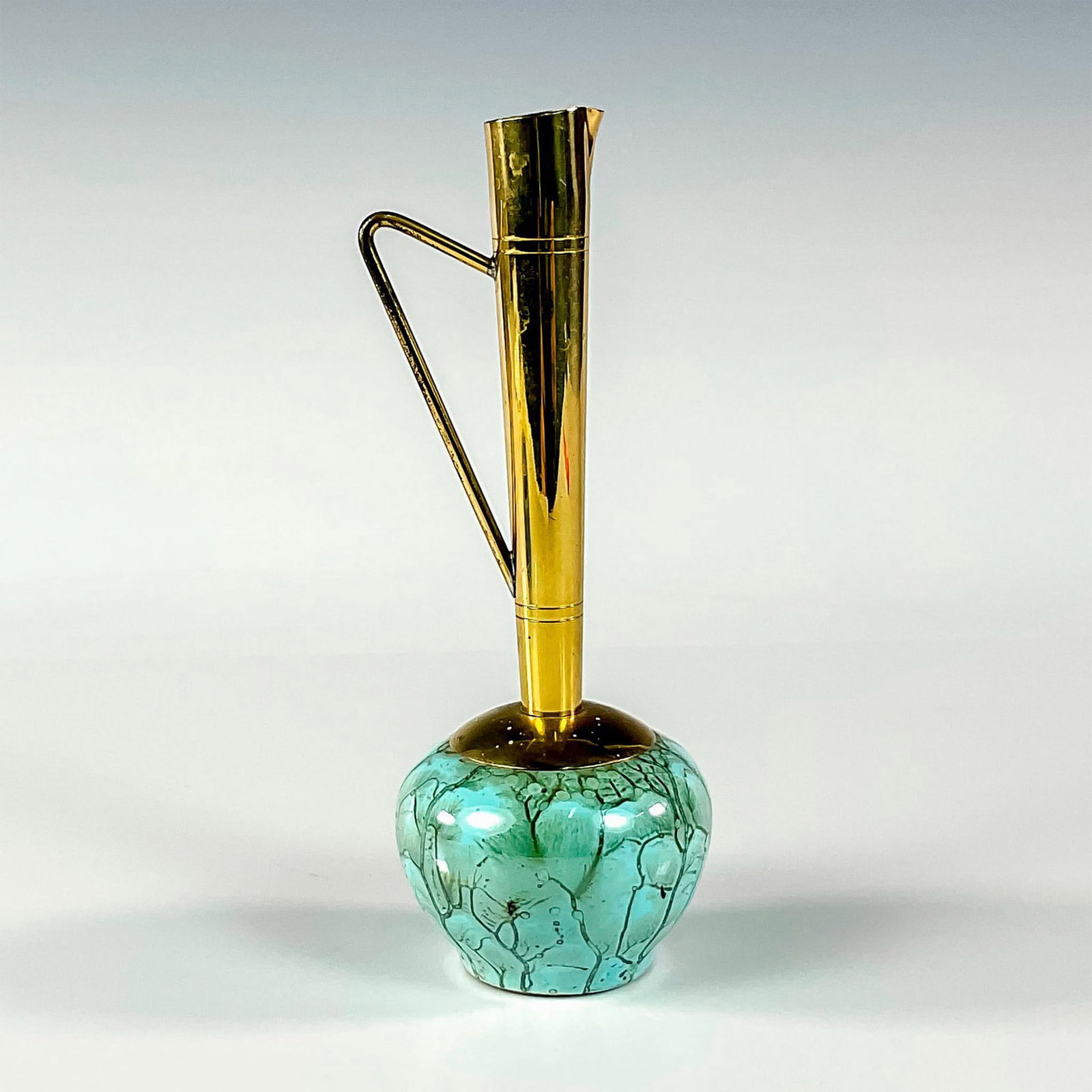 Unusual Delft Mid-Century Modern Lustre Glaze Bud Vase: Turquoise with lustre finish and branch patterning. Round body. Narrow brass spout with handle. Hand Painted Delft Holland on bottom. This item has no reserve. Dimensions: 2.5"W x 6.75"H Manufacturer: