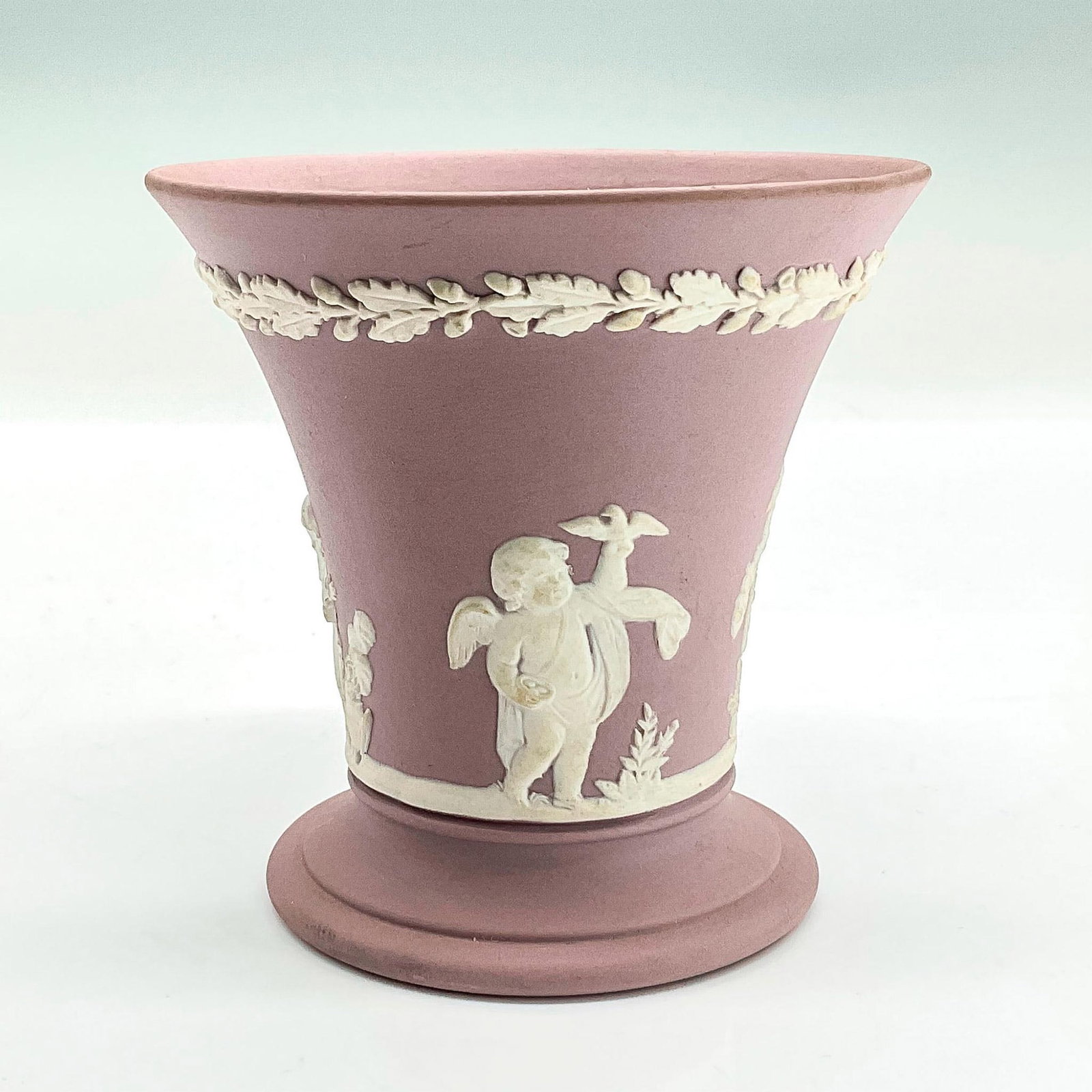 Wedgwood Lilac Jasperware Vase: Matte porcelain vase in light purple with neoclassical white sprigged decoration in low-relief. Wedgwood stamp. Dimensions: 3.5"H x 3.25"dia Manufacturer: Wedgwood Country of Origin: England