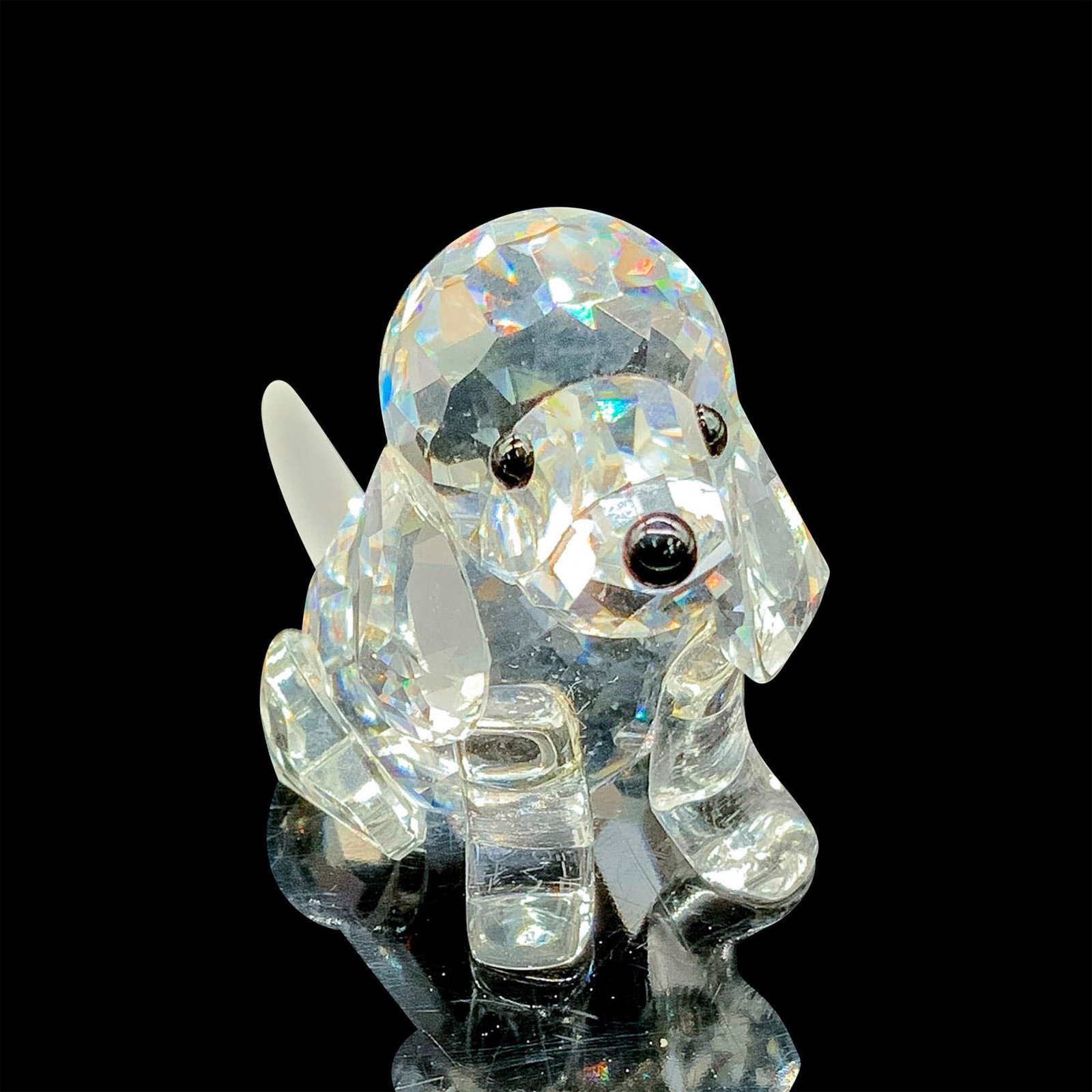 Swarovski Silver Crystal Figurine, Beagle Puppy: This adorable sitting beagle has a faceted clear crystal body with a frosted crystal tail. Swarovski etched backstamp. This item has its original box measuring 3.25"dia. x 2.5"H. Artist: Adi Stocker D