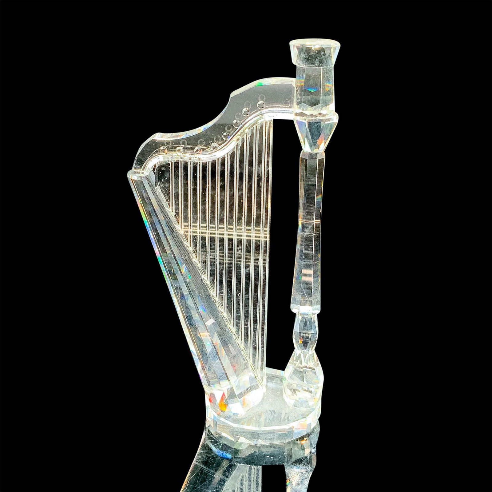 Swarovski Silver Crystal Figurine, Harp: This retired Swarovski crystal harp was part of the “Crystal Melodies” collection and is made from detailed clear faceted crystal. Item has its original box measuring 5"dia. x 6"H. Artist: Mar