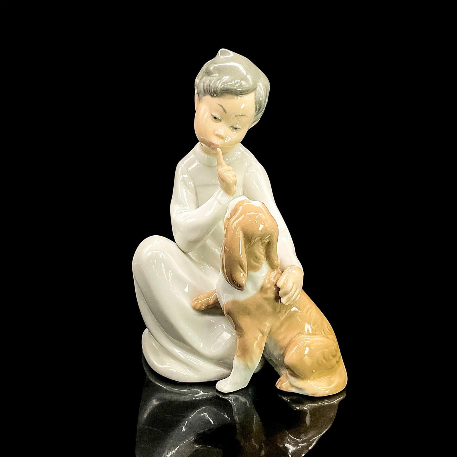 Boy With Dog 1004522 - Lladro Porcelain Figurine: Glossy finish; Lladro backstamp. Artist: Vicente Martinez Issued: 1970 - 1997 Dimensions: 7.5"H Manufacturer: Lladro Country of Origin: Spain