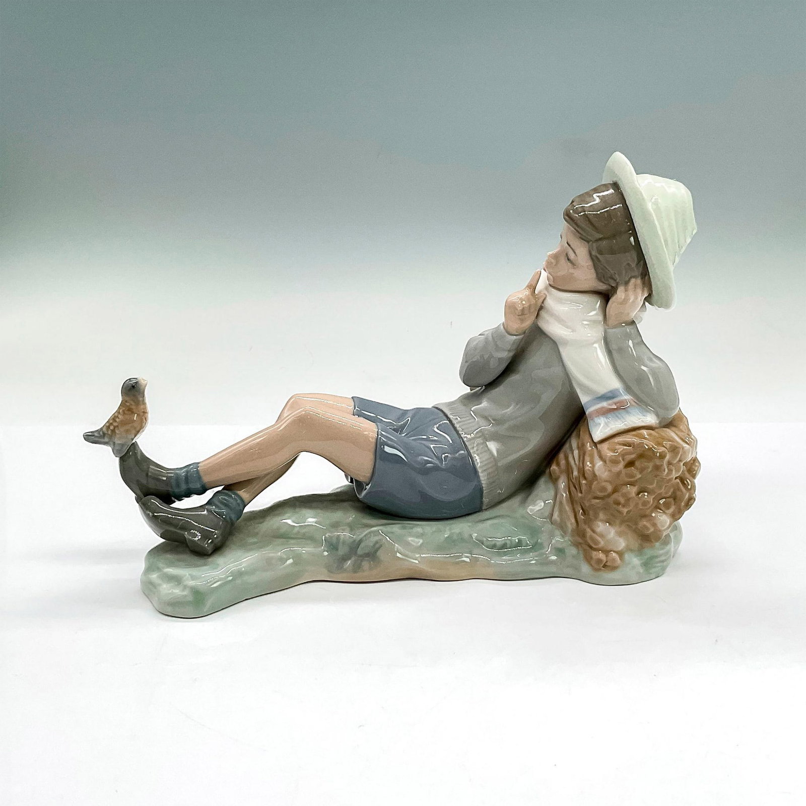 Shepherd W/bird 1004730 - Lladro Porcelain Figurine: Glossy finish; Lladro backstamp. Artist: Vicente Martinez Issued: 1970 - 1985 Dimensions: 6.25"H Manufacturer: Lladro Country of Origin: Spain