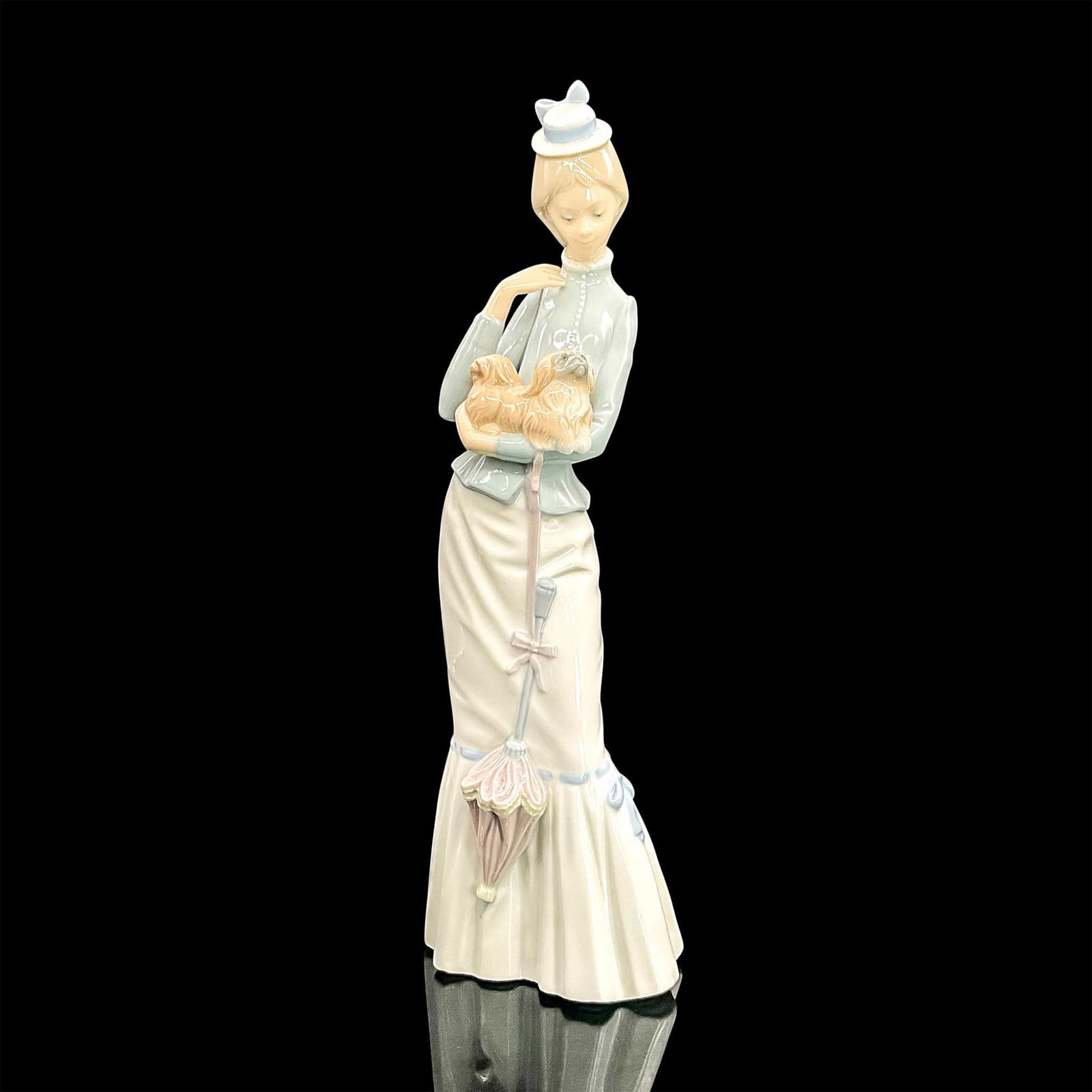 Walk With The Dog 1004893 - Lladro Porcelain Figurine: Glossy finish; Lladro backstamp. Artist: Jose Roig Issued: 1974 - 2004 Dimensions: 15"H x 4.75"W Manufacturer: Lladro Country of Origin: Spain
