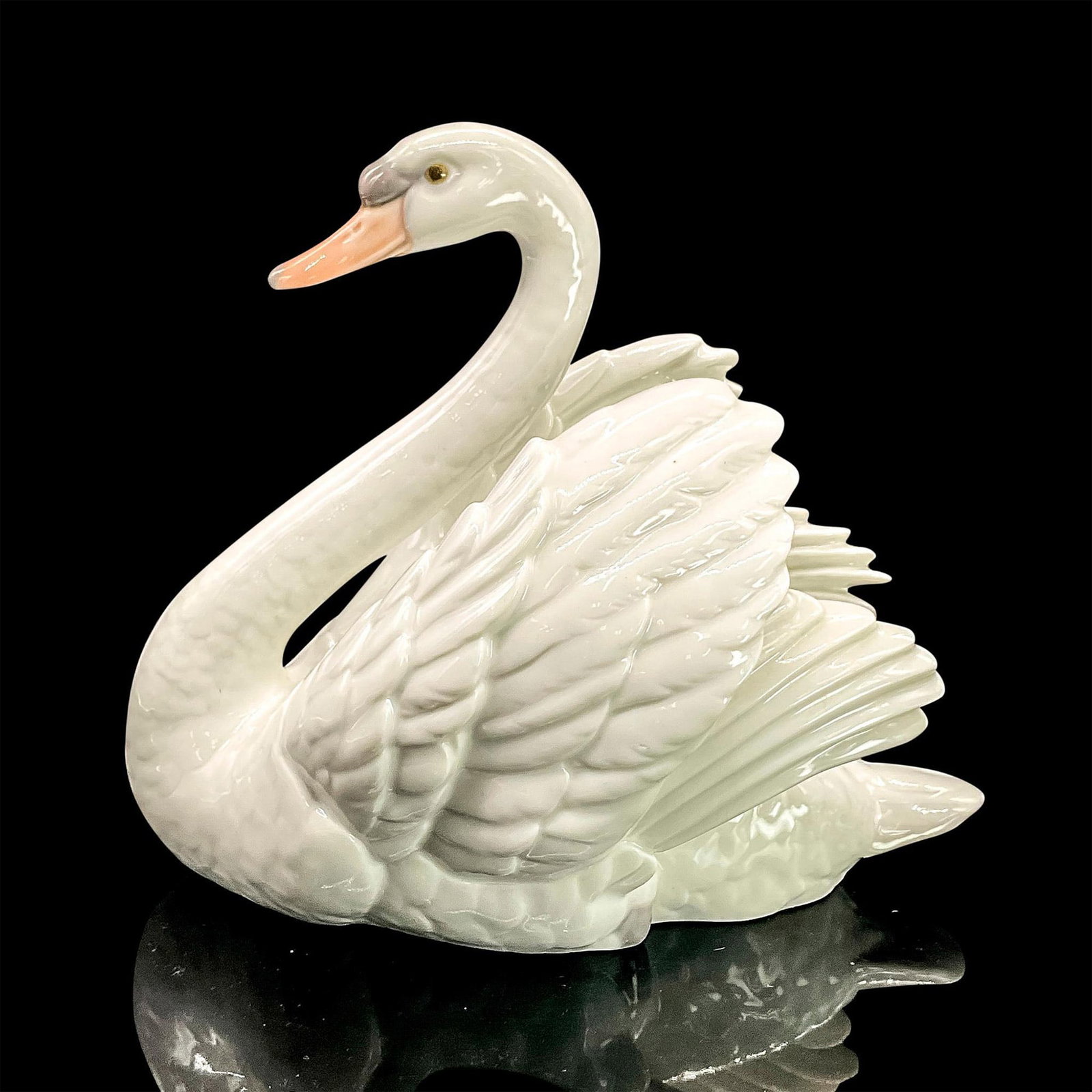 Swan With Wings Spread 1005231 - Lladro Porcelain Figurine: Glossy finish; Lladro backstamp. Artist: Francisco Catala Issued: 1984 - 2007 Dimensions: 7.5"H x 7.5"W Manufacturer: Lladro Country of Origin: Spain