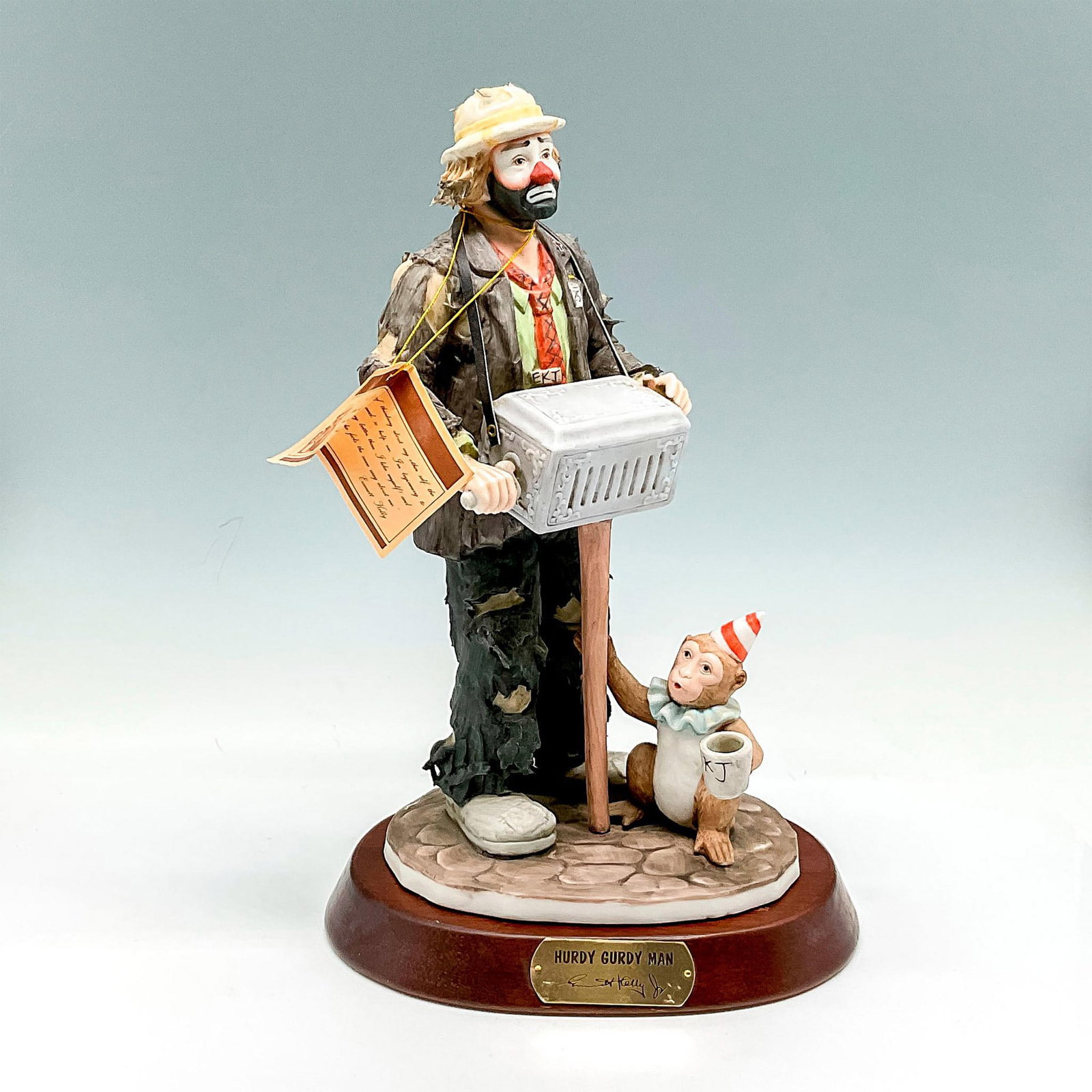 Flambro Imports Figurine, Emmett Kelly, Jr. Hurdy Gurdy Man: Clown figural in tattered clothes with his music box and monkey. Signed. Limited edition 2656 of 9500. Flambro backstamp. This item has a base included: 1"H x 7"dia. Issued: 20th century Dimensions: 5