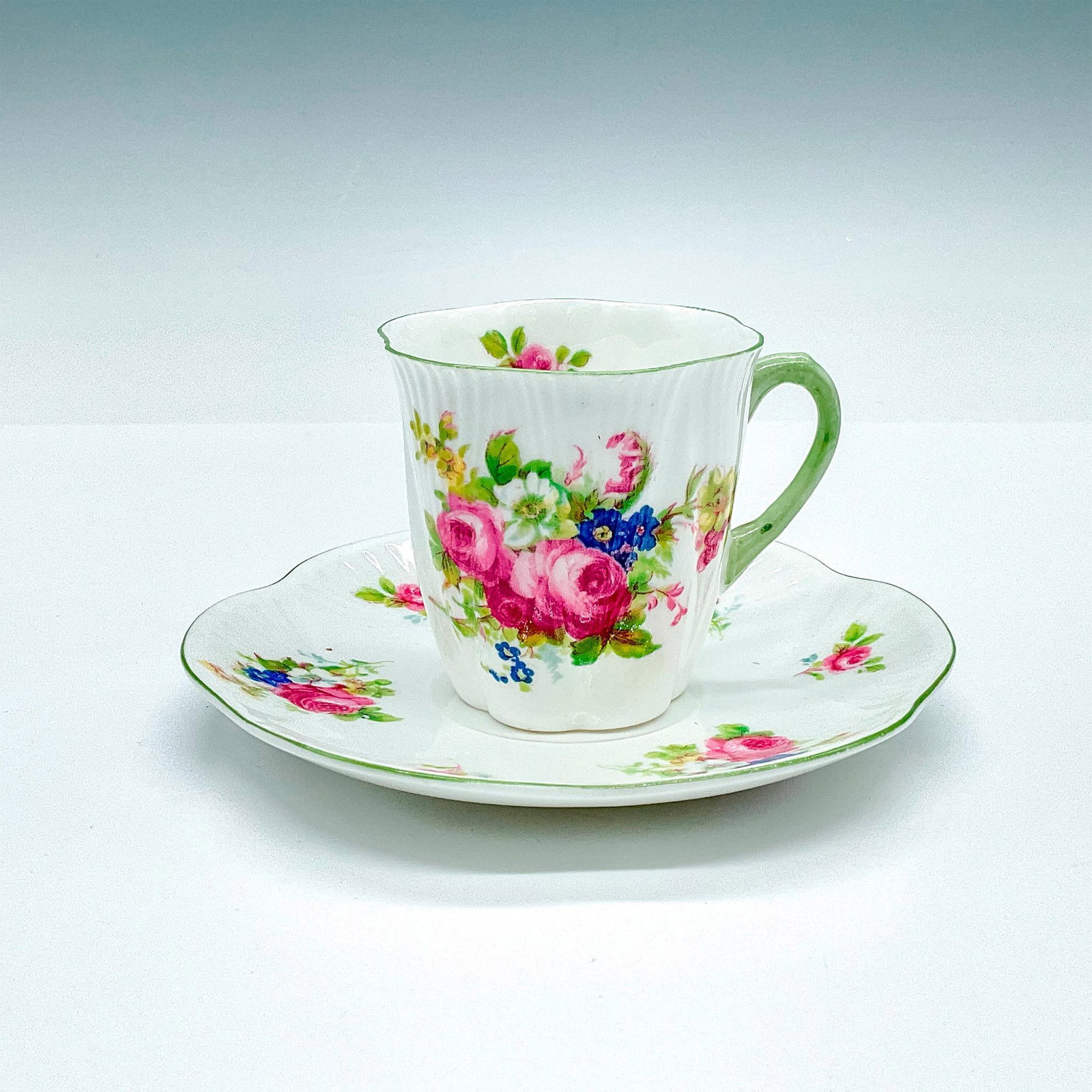 Shelly Bone China Teacup & Saucer Hulme's Rose Bouquet: The pattern number 13240 for Shelley China is called Hulme's Rose Bouquet. The pattern features small posies of pink roses, blue and white flowers. Cup measures: 3"L x 2.5"W x 2.5"H. Saucer measures: 