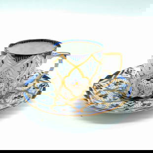 Moritz Zdekauer Blue and Gold Geometric Demitasse & Saucer: Geometric blue and gold pattern on white porcelain. Espresso cup: 2.5"L x 2"W x 2"H. Saucer: 4"dia. Country of Origin: Austria