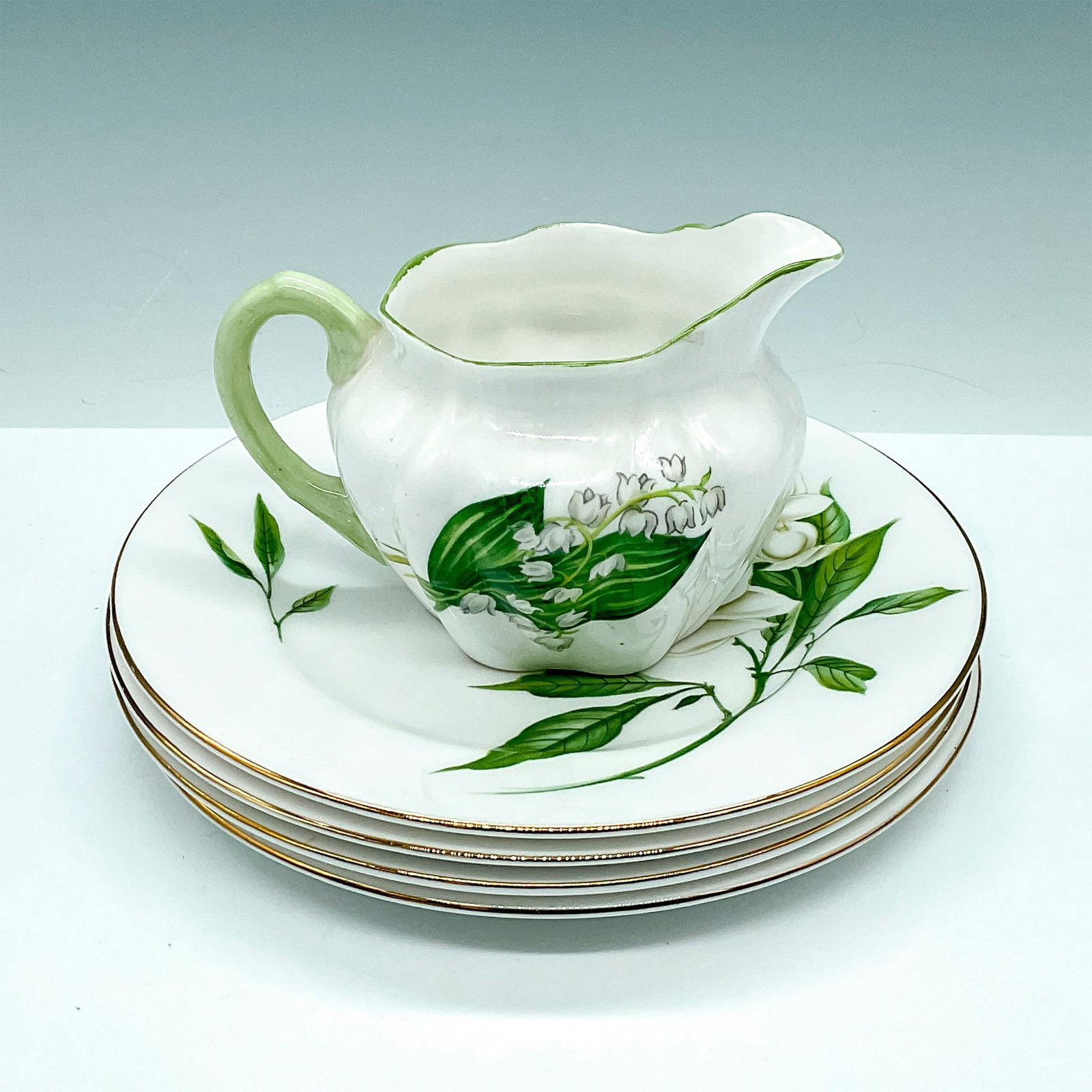 5pc Shelly China Bread & Butter Plates with Small Creamer: This beautiful collection includes 4 small plates in the Syringa pattern 14009, featuring white flowers and gold trim, along with a small milk/cream pitcher in the Lily of the Valley pattern 13822 wit