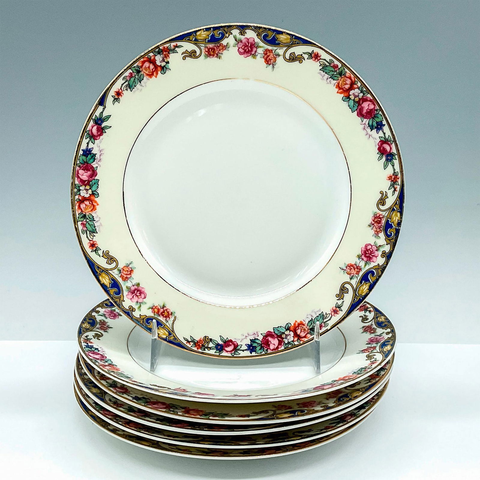 6pc TK Thun Porcelain Plates: Beautiful set of 6 gold rimmed and floral designed fine bone porcelain luncheon/bread plates from Czechoslovakia by the TK Thun company. TK Thun backstamp. Issued: 20th Century Dimensions: 0.75"H x 6.