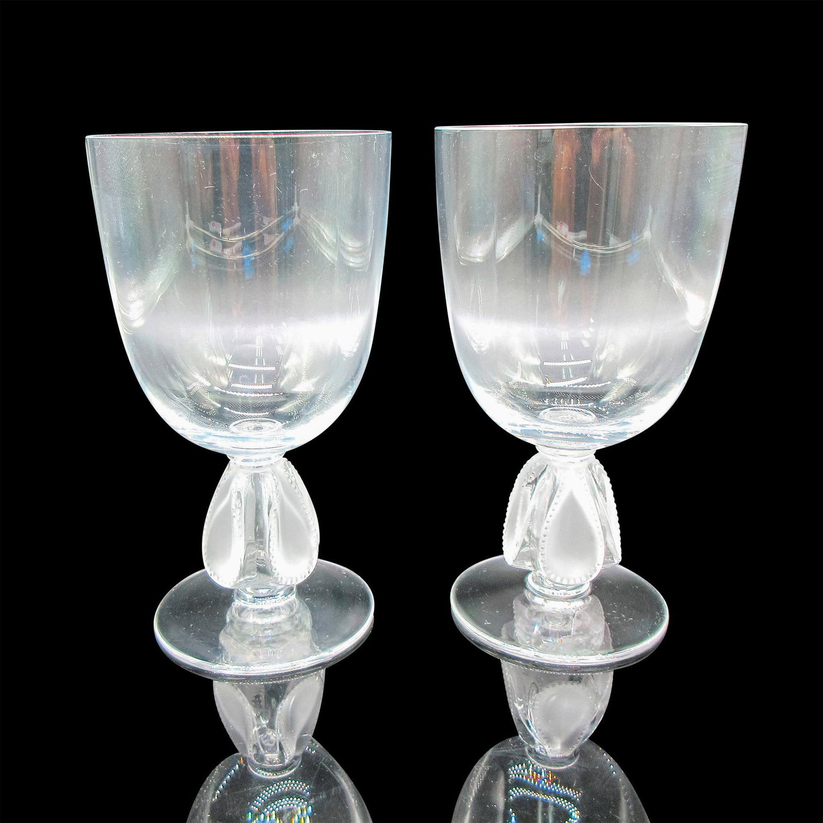 2pc Lalique Crystal Wine Glasses, Bellini: Clear glass body with frosted teardrop in raised dimpled design. Lalique etched mark. Dimensions: 3"L x 3"W x 5.25"H Manufacturer: Lalique Country of Origin: France Provenance: Collection of Marie-Cla