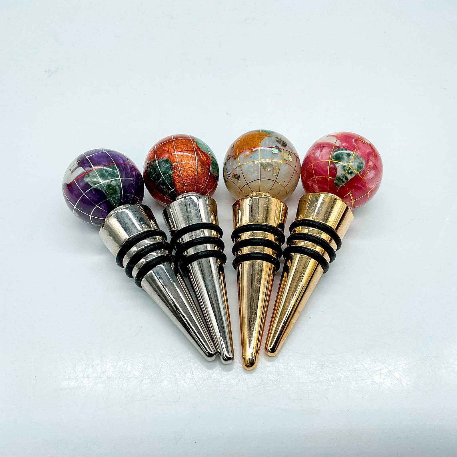 4pc Gemstone Globe Wine Bottle Stoppers: Elevate your wine collection with this set of four handcrafted gemstone globe wine stoppers. These items have their original box which measure 5"L x 2"W x 1.75"H. Dimensions: 3.5"H x 1.25" dia.