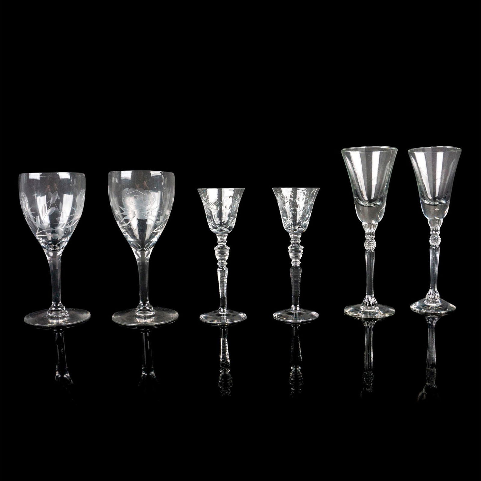 6pc Mixed Lot of Drinkware Glasses, Cordials & Liqueur: Includes 2 etched glasses with banded stems, 2 etched glasses with clear stems and 2 clear body with jeweled topped stems. Largest piece: 6"H x 2"dia. Issued: 20th century