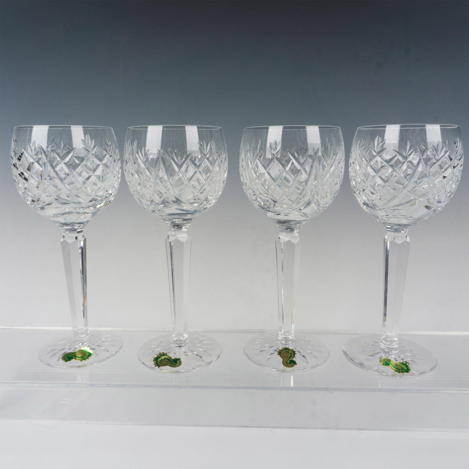 4pc Waterford Crystal Hock Wine Glasses, Donegal: A nice grouping of clear crystal hock wine glasses, each having lattice cut pattern along the bowl and starburst patterned foot. Waterford factory label. Waterford etched backstamp. Issued: 20th c. Di