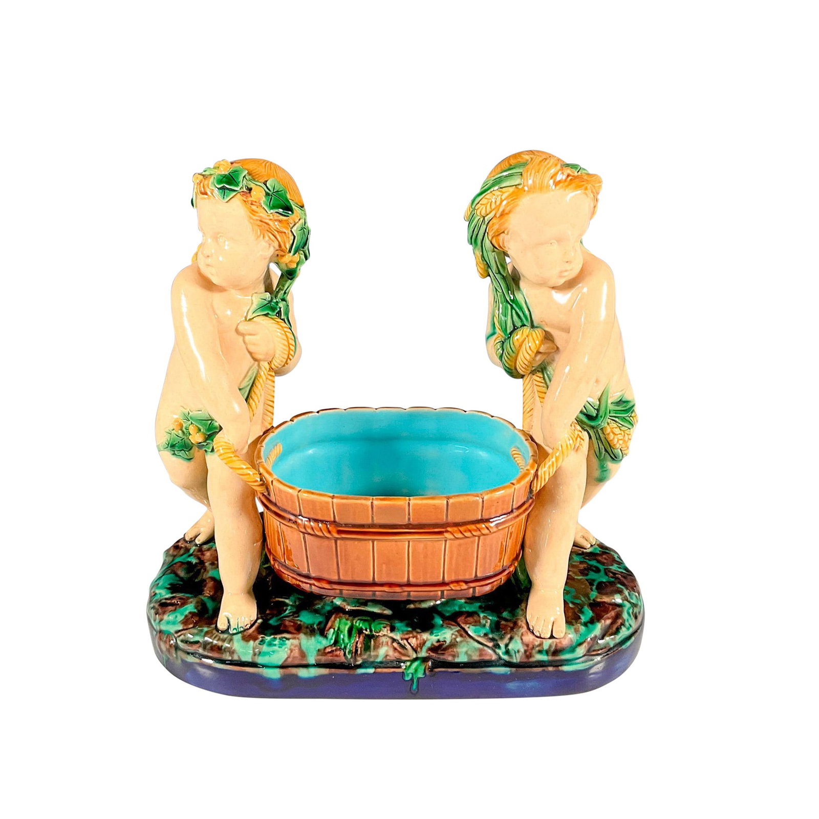Antique Minton Majolica Centerpiece, Cupids Carrying Bucket: Pair of walking cupids carrying a large rope handled bucket. Glossy finish. Impressed mark Minton 298. Issued: 1870 Dimensions: 11.25"L x 5.5"W x 11"H Manufacturer: Minton Country of Origin: England
