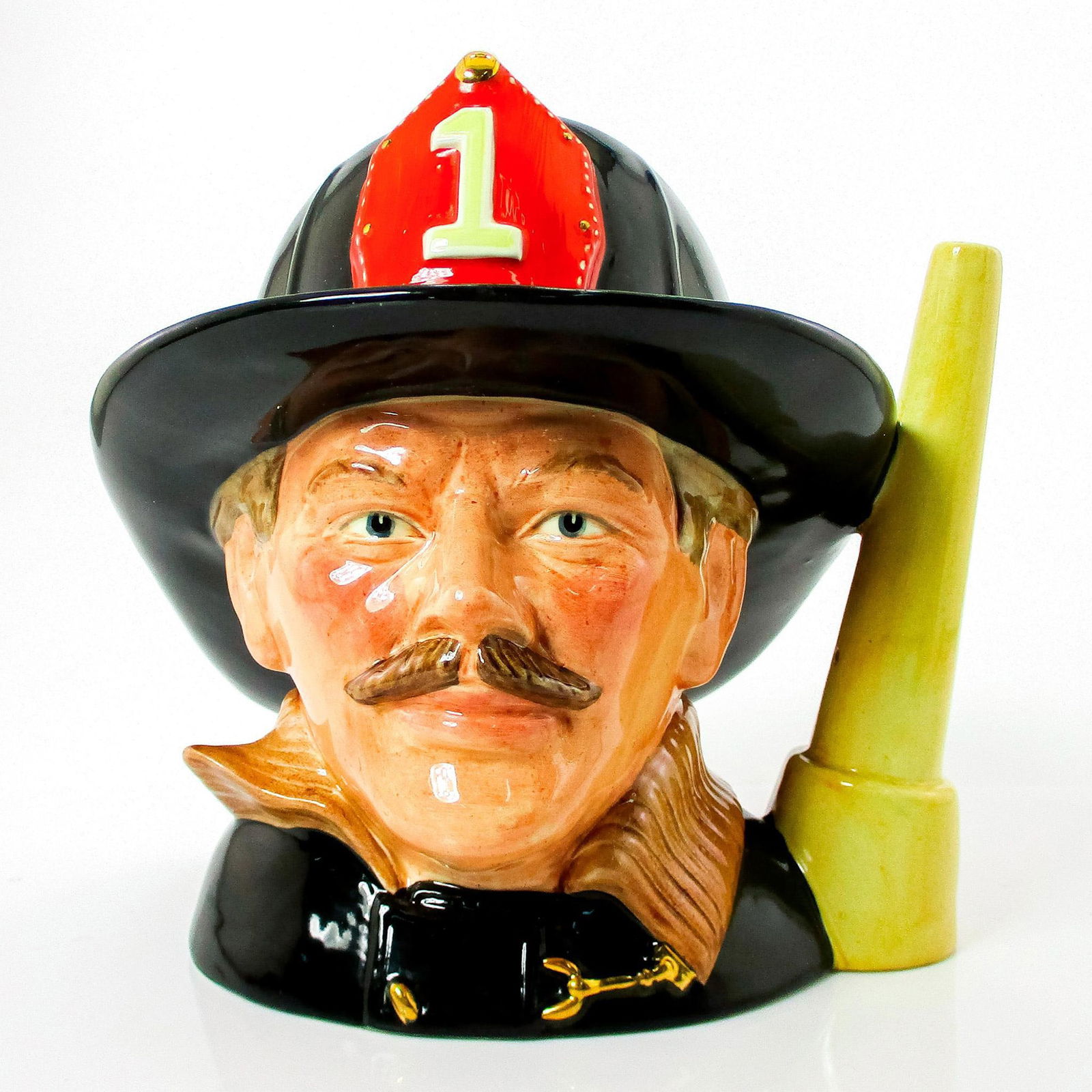 Fireman (Fire Hose Handle) D6697 - Large - Royal Doulton Character Jug: Style One. Black, brown and red helmet badge. Launched exclusively by Griffith Pottery House in 1983, The Fireman jug was then released into the general range in 1984. Varieties of the handle exist, w