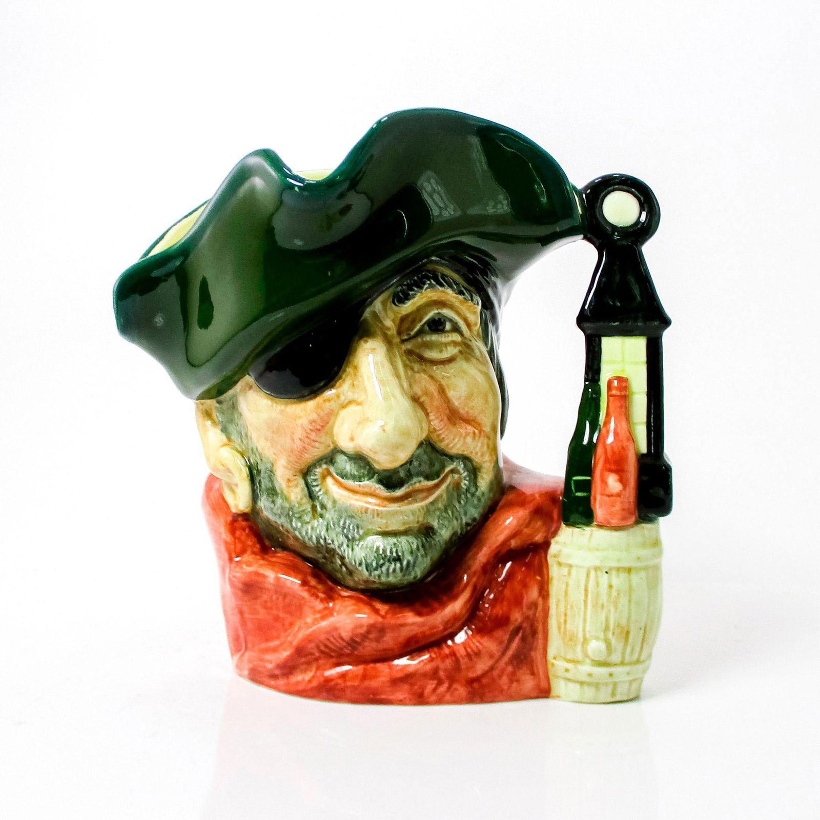 Smuggler D6616 - Large - Royal Doulton Character Jug: Green hat, red scarf. The detailing on the barrel of the small-size jug is often less distinguishable than that on the large jug. Royal Doulton backstamp. Artist: David B. Biggs Issued: 1968 - 1981 Di