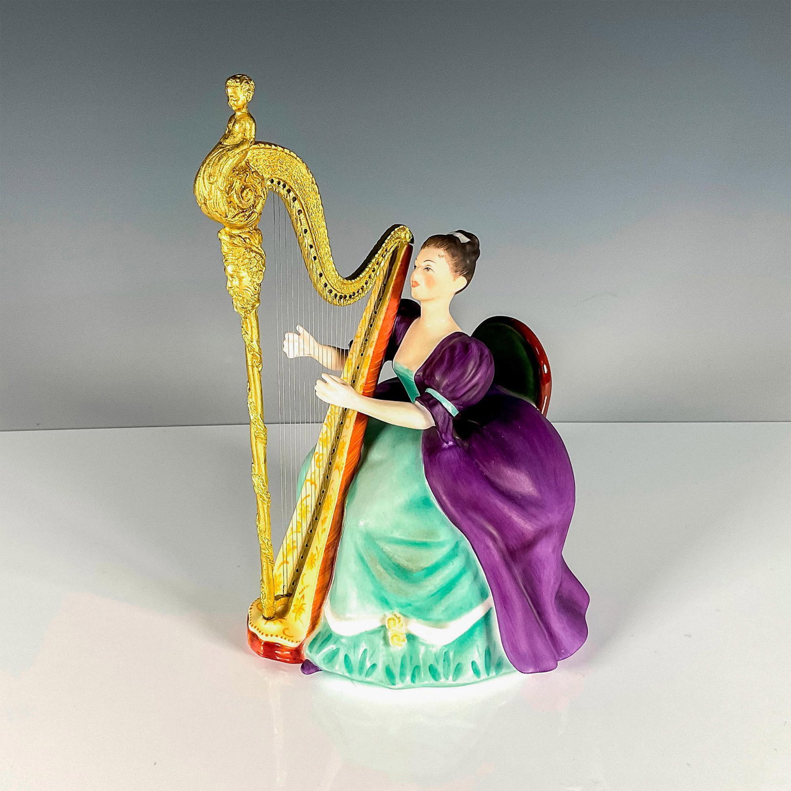 Harp - HN2482 - Royal Doulton Figurine: Artist: Peggy Davies Issued: 1973 Dimensions: 8.75"H Edition Number: 635 Edition Size: 750 Manufacturer: Royal Doulton Country of Origin: England