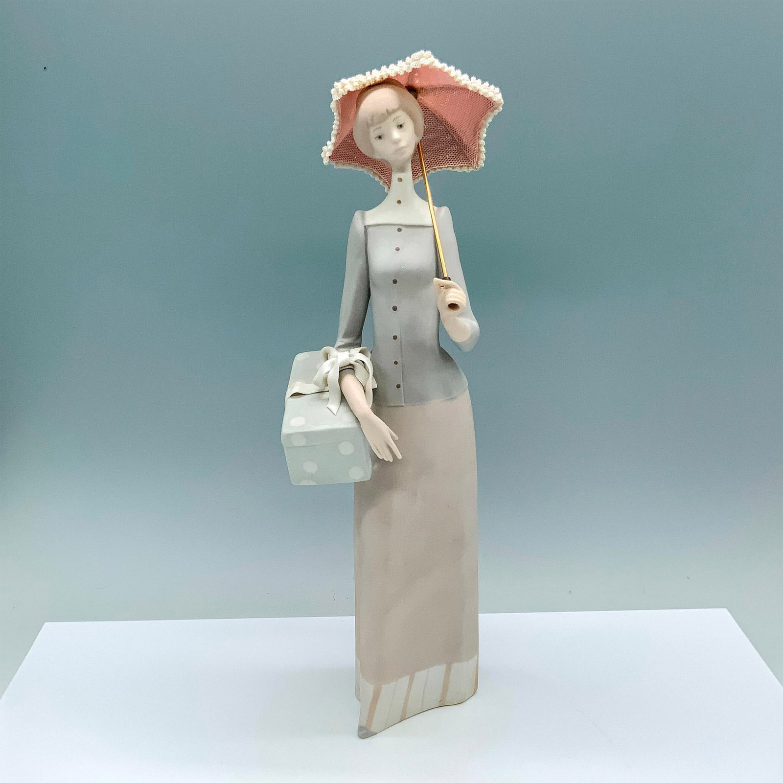Dressmaker 1014700 - Lladro Porcelain Figurine: Matte finish; Lladro backstamp. Artist: Vicente Martinez Issued: 1970 - 1991 Dimensions: 14.25"H Manufacturer: Lladro Country of Origin: Spain