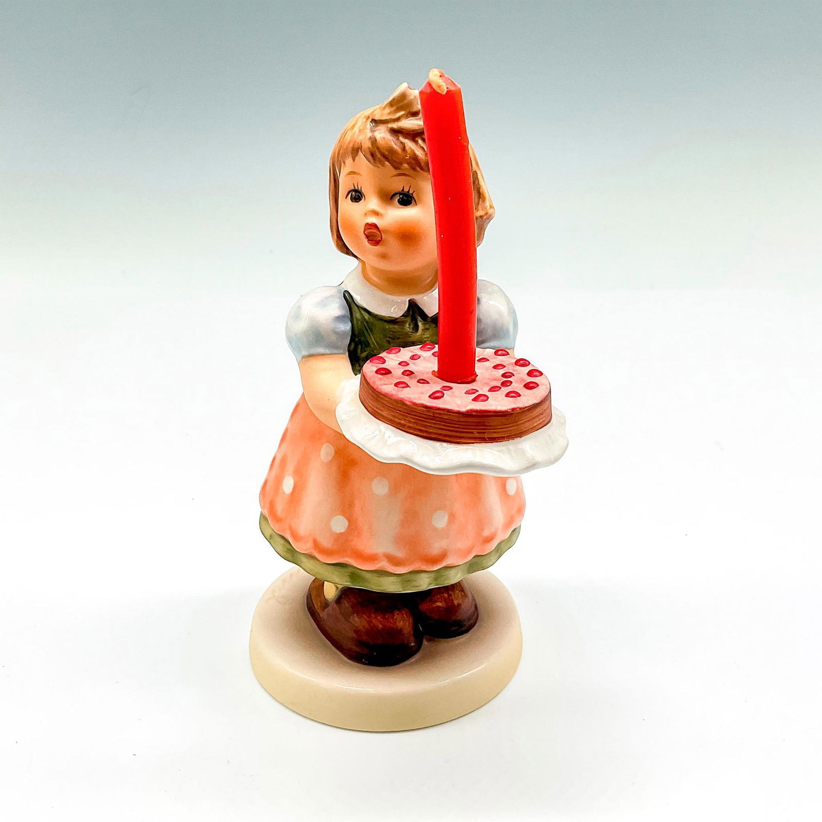 Goebel Hummel Porcelain Figurine, Birthday Candle: This figural is Special Edition for Members of Goebel Collectors Club, celebrating 10 years. Hand painted little girl holding birthday cake, colored in soft colors of green, peach and browns. Goebel b