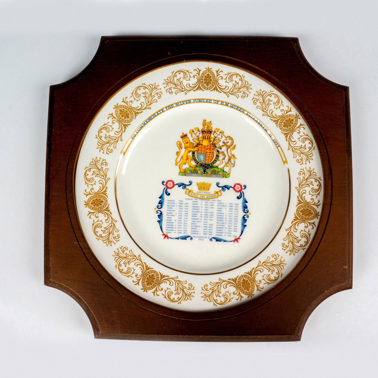 Aynsley English Bone China Silver Jubilee Plaque: Housed in a wooden frame, a plate commemorating the 25th Silver Jubilee of Queen Elizabeth II in 1977. The plate has a list of the kings and queens of England. Wooden frame: 13"W x 13"H x 1"D. Plate: