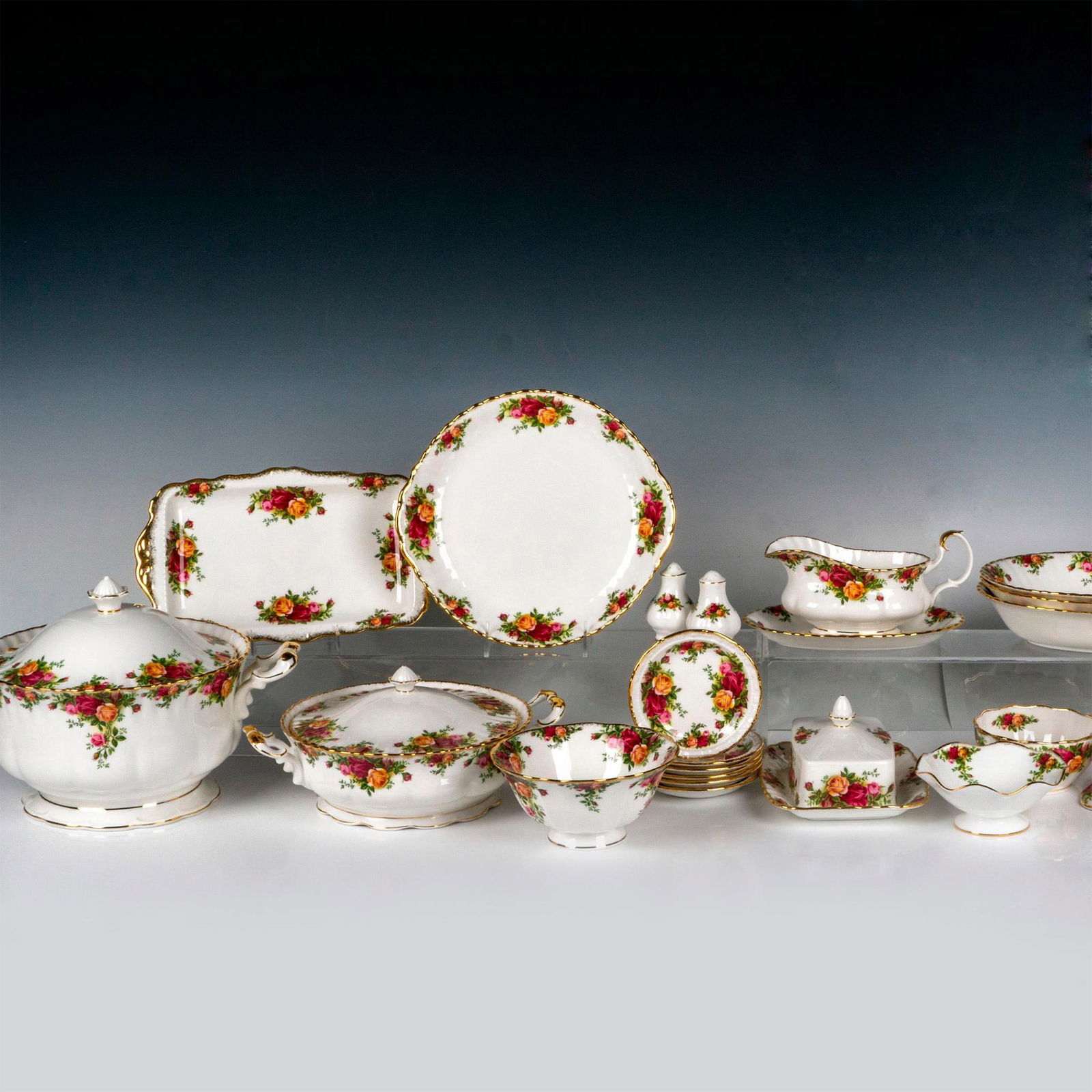 28pc Royal Albert Serveware, Old Country Roses: Bone china serving tableware in magenta, gold and pink roses design; gold rims and handles. Royal Albert backstamp. Pedestal bowl 5.25"H x 7.25" dia. Footed bowl 3"H x 6.25" dia. Ruffle edge footed bo