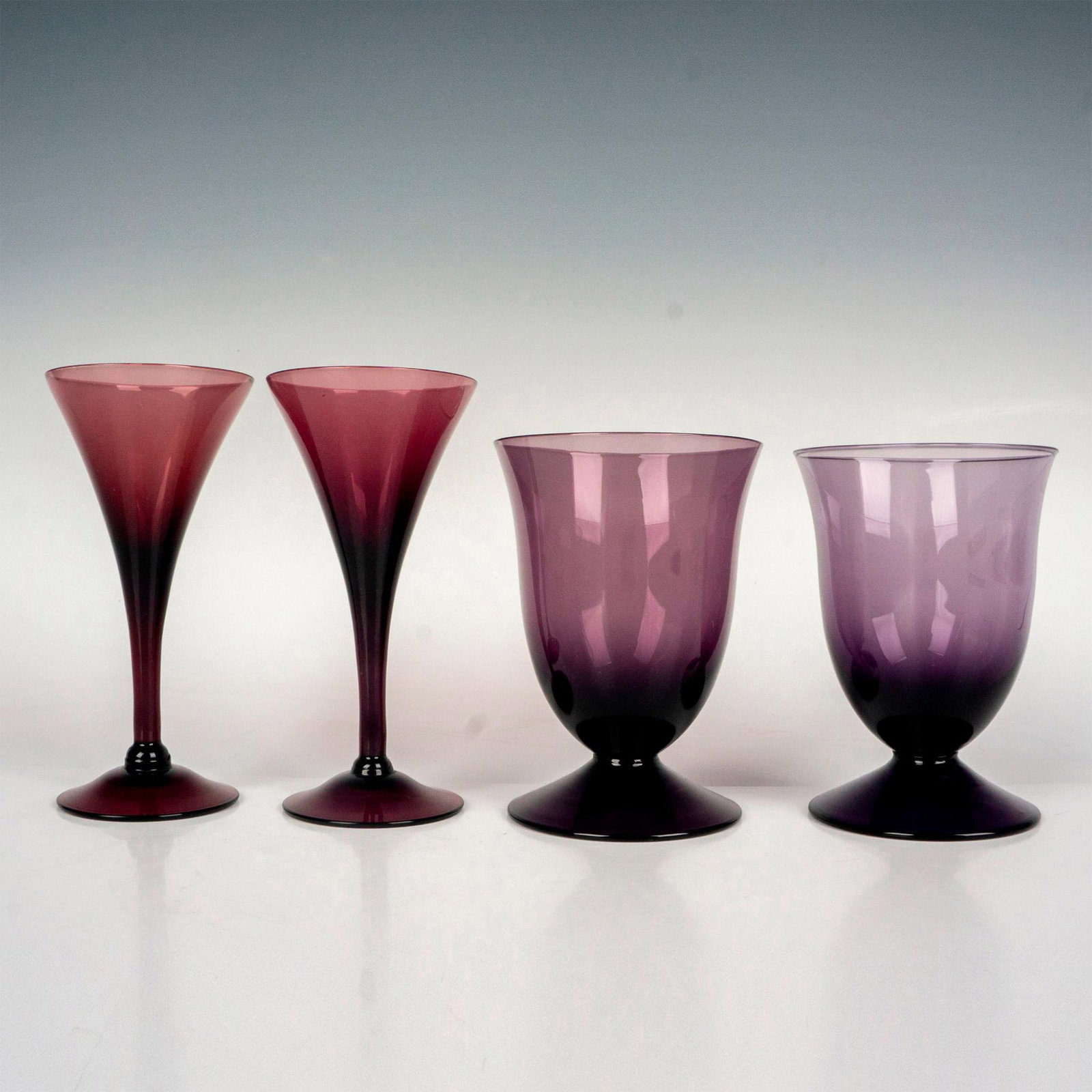 4pc Purple Glasses, Cordial and Water: Two footed fluted glasses, 4.25"H x 3.25"dia. Two cordial glasses, 5.25"H x 2.5"dia.